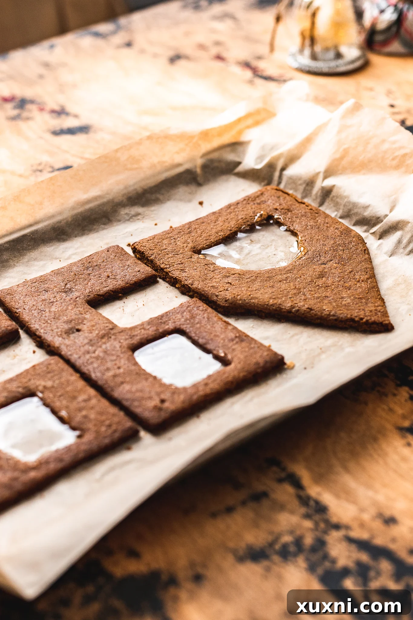 Gingerbread house with vibrant stained glass windows made from melted isomalt