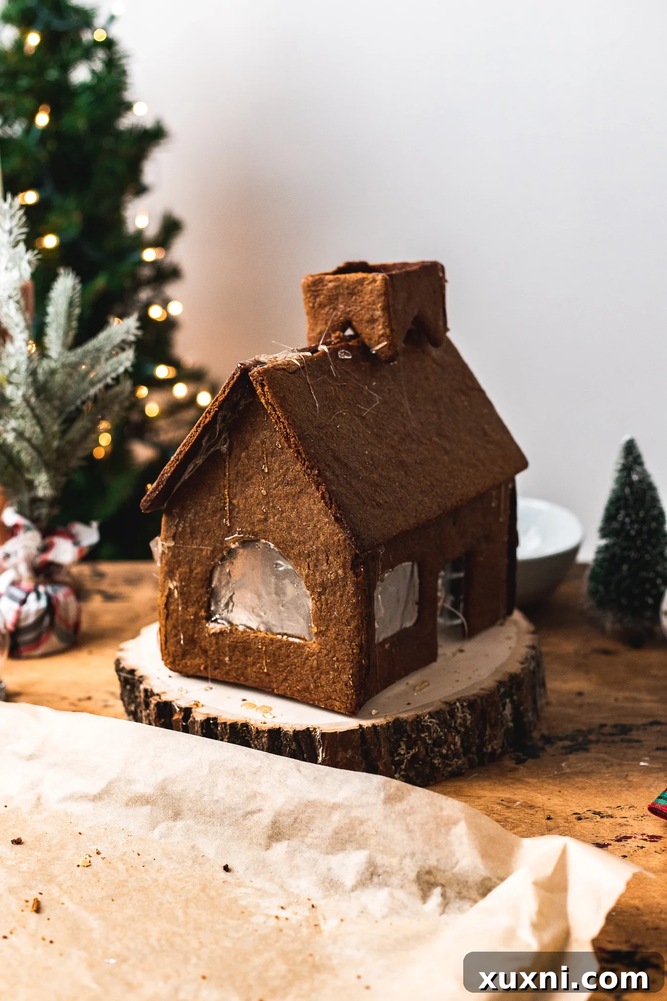 Fully assembled vegan gingerbread house with the roof in place, awaiting decoration