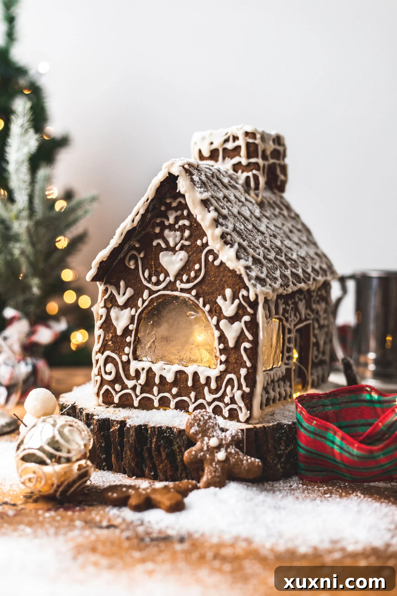 Beautifully decorated vegan gingerbread house with colorful candies and intricate icing details