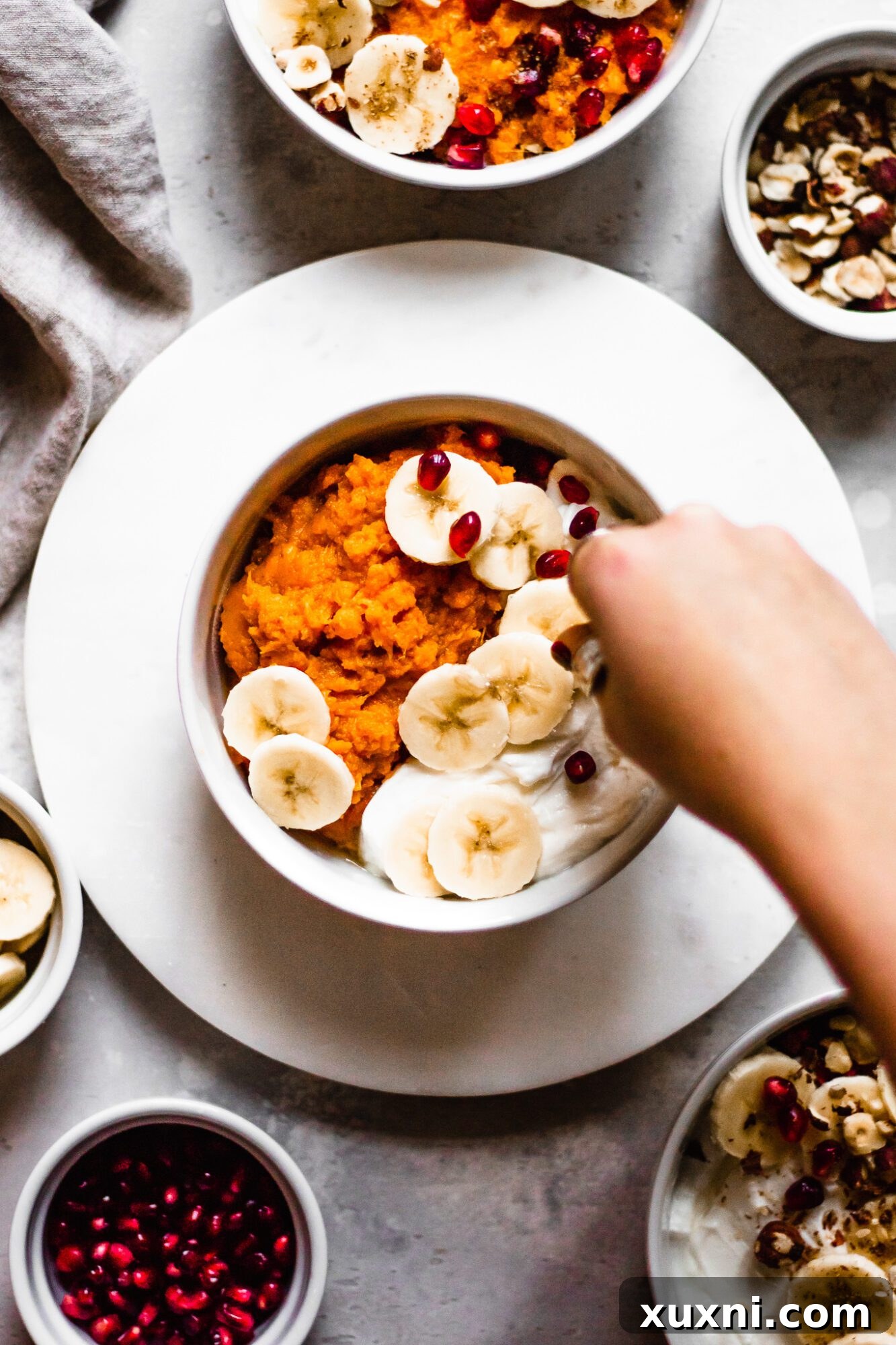 pomegranate seeds topping sweet potato bowl