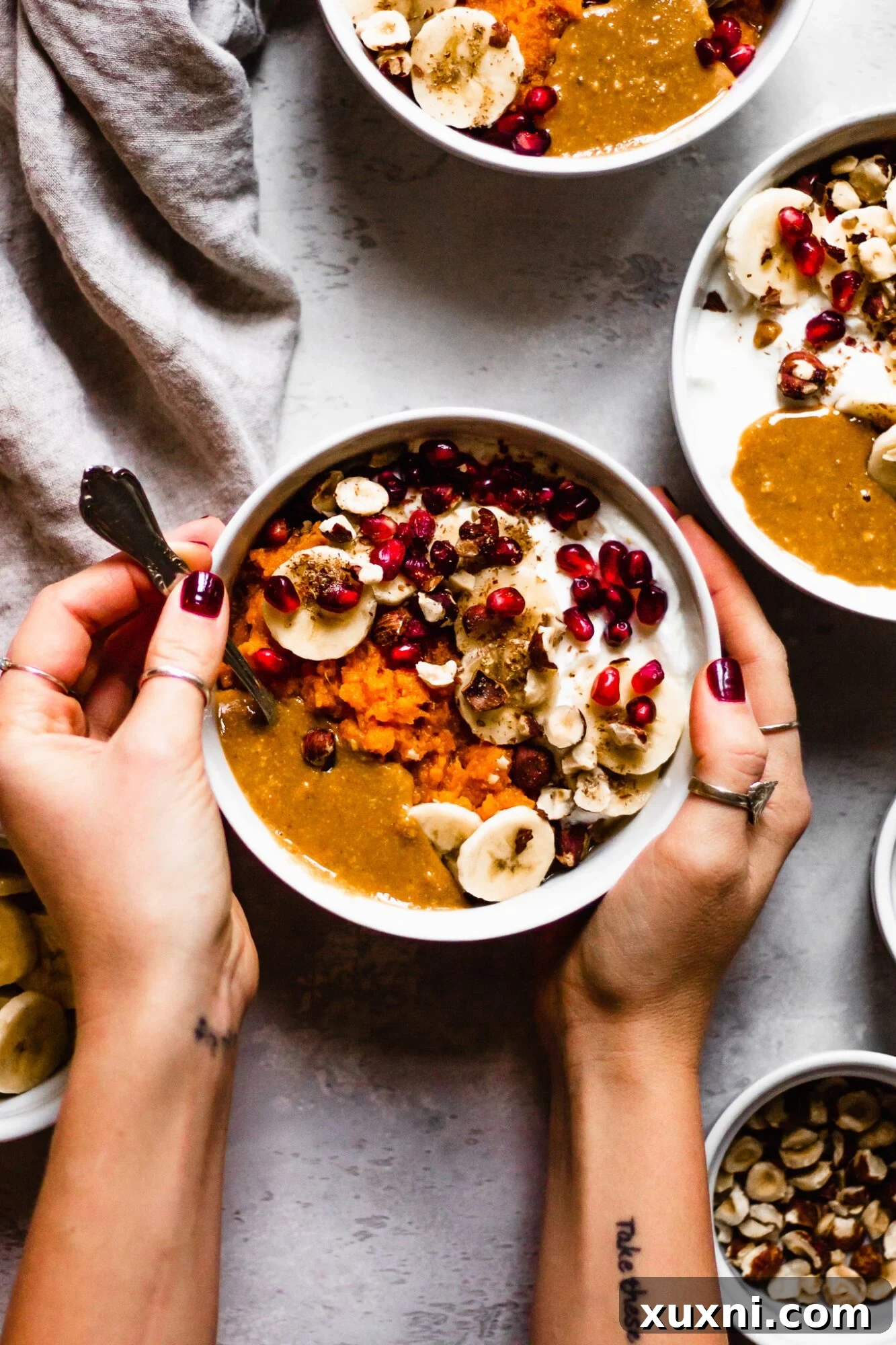 hand reaching for spoon in sweet potato bowl