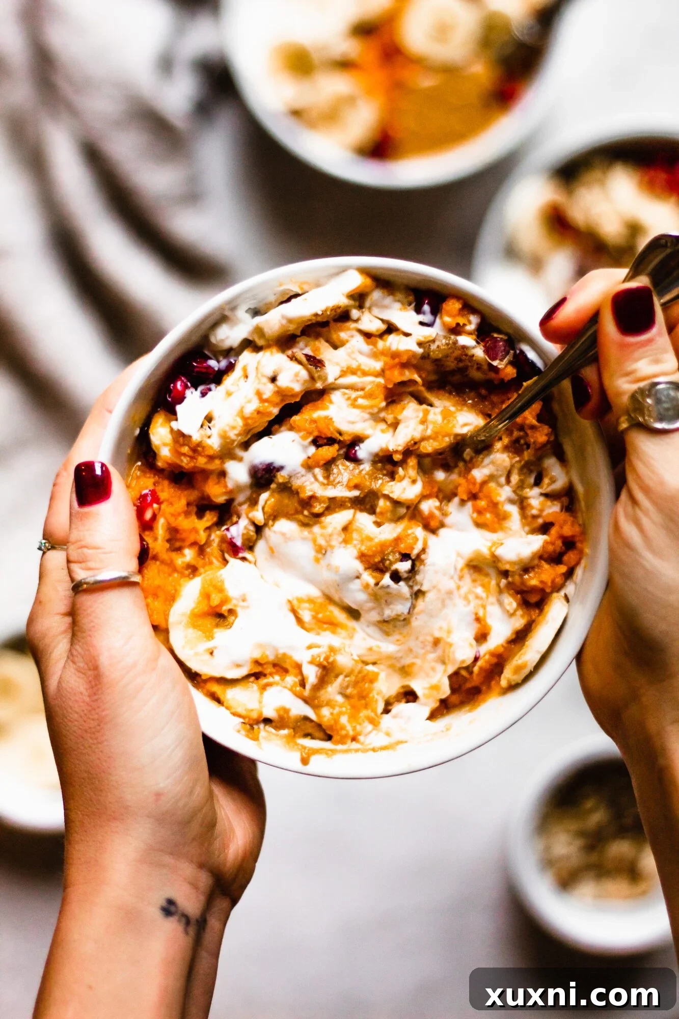 hand mixing together sweet potato bowl
