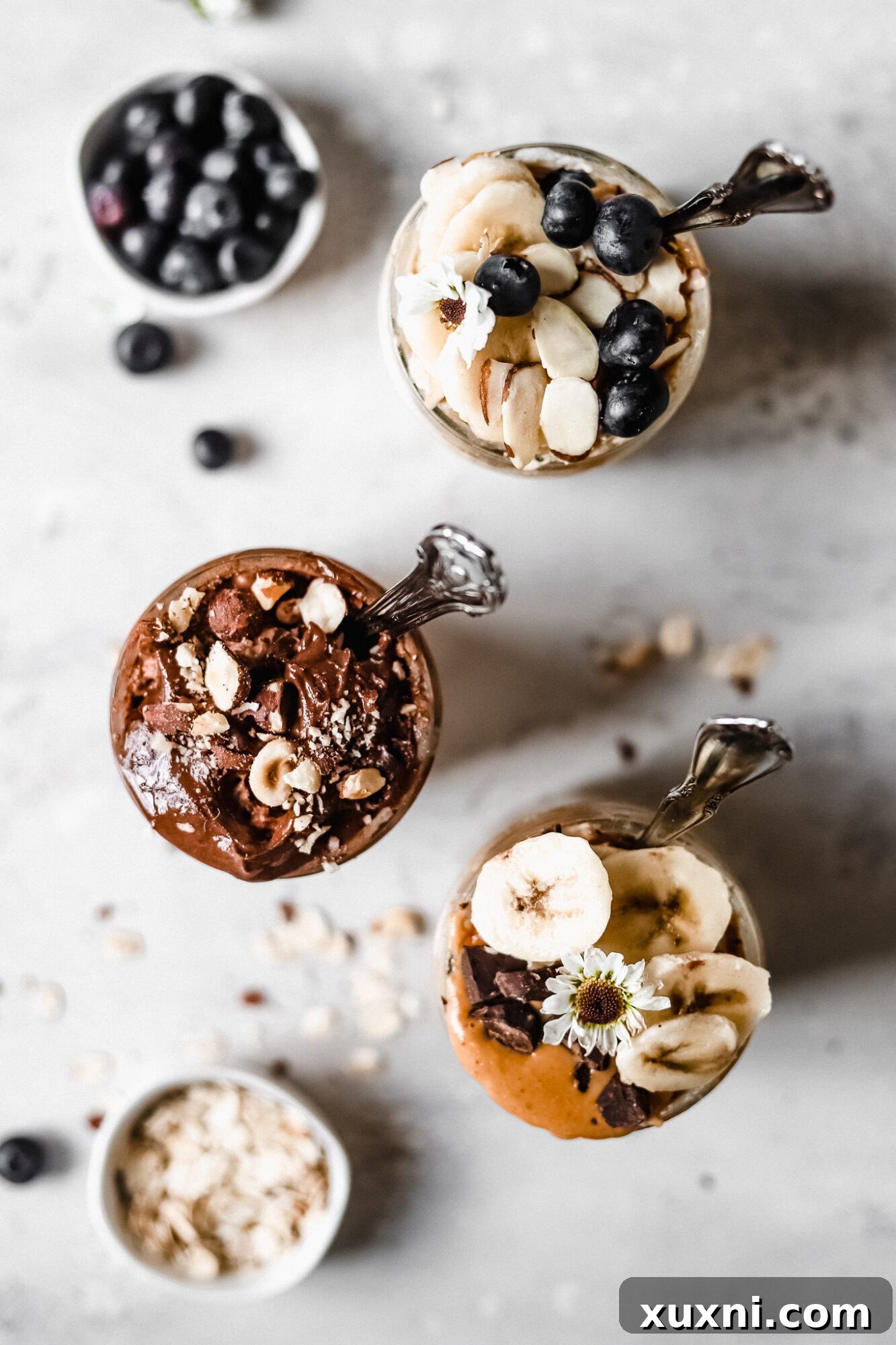 Overhead shot of three different flavored overnight oats in jars