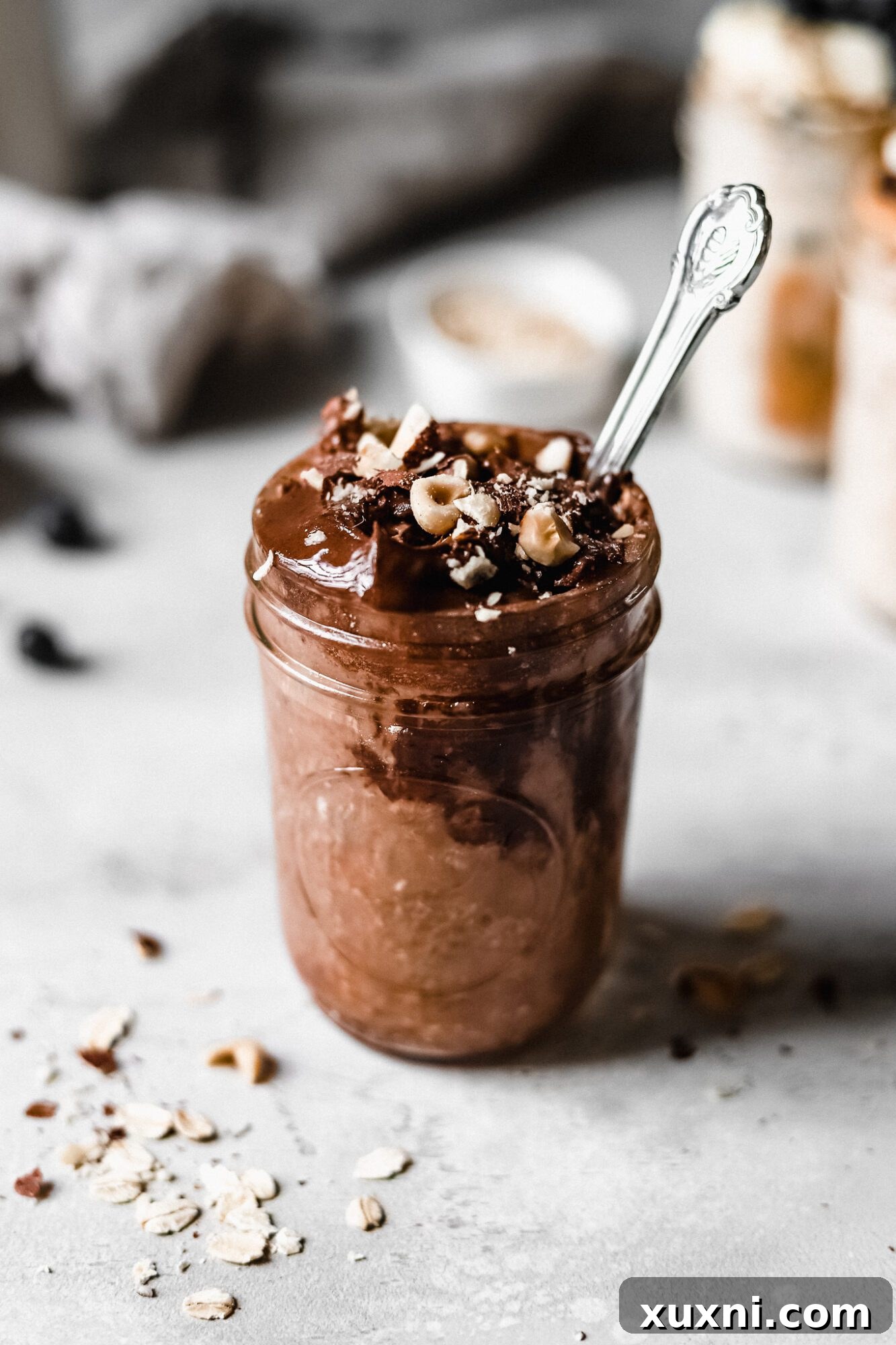 Jar of rich chocolate hazelnut overnight oats, ready to eat