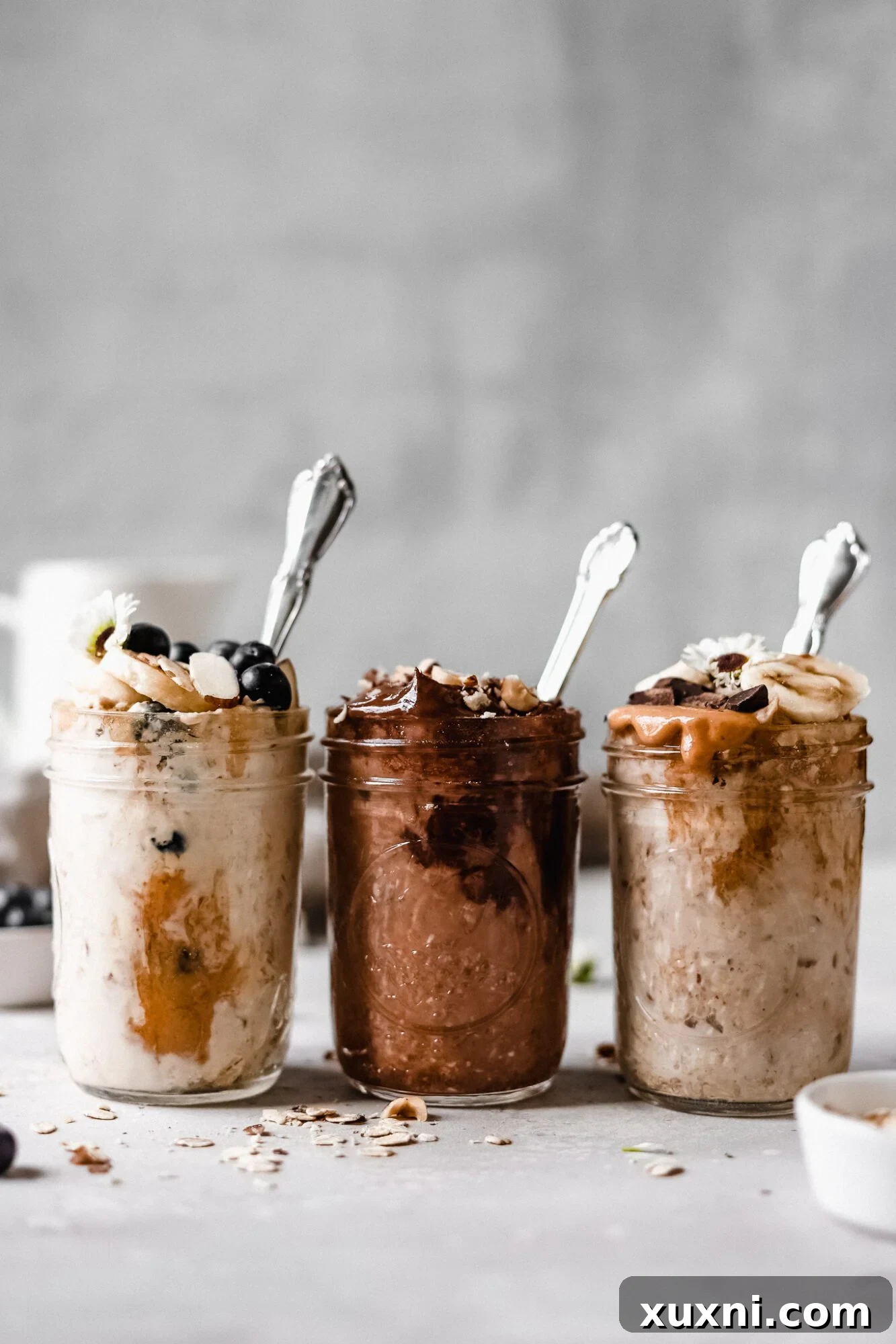 Three jars of diverse overnight oats flavors lined up