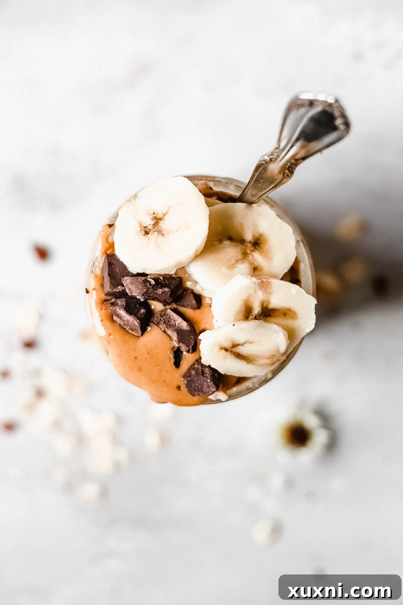 Overhead view of peanut butter banana overnight oats with toppings