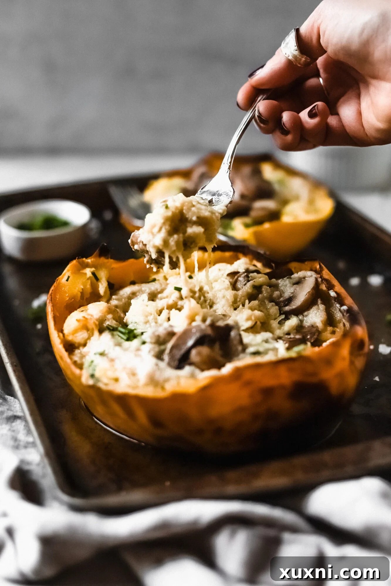 A fork pulling up creamy spaghetti squash strands, illustrating the perfect texture and sauce coating.