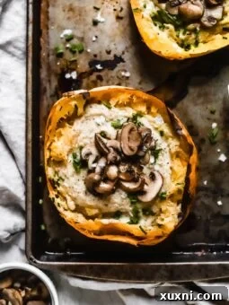 Close up of a spaghetti squash boat, highlighting its creamy vegan Alfredo filling.