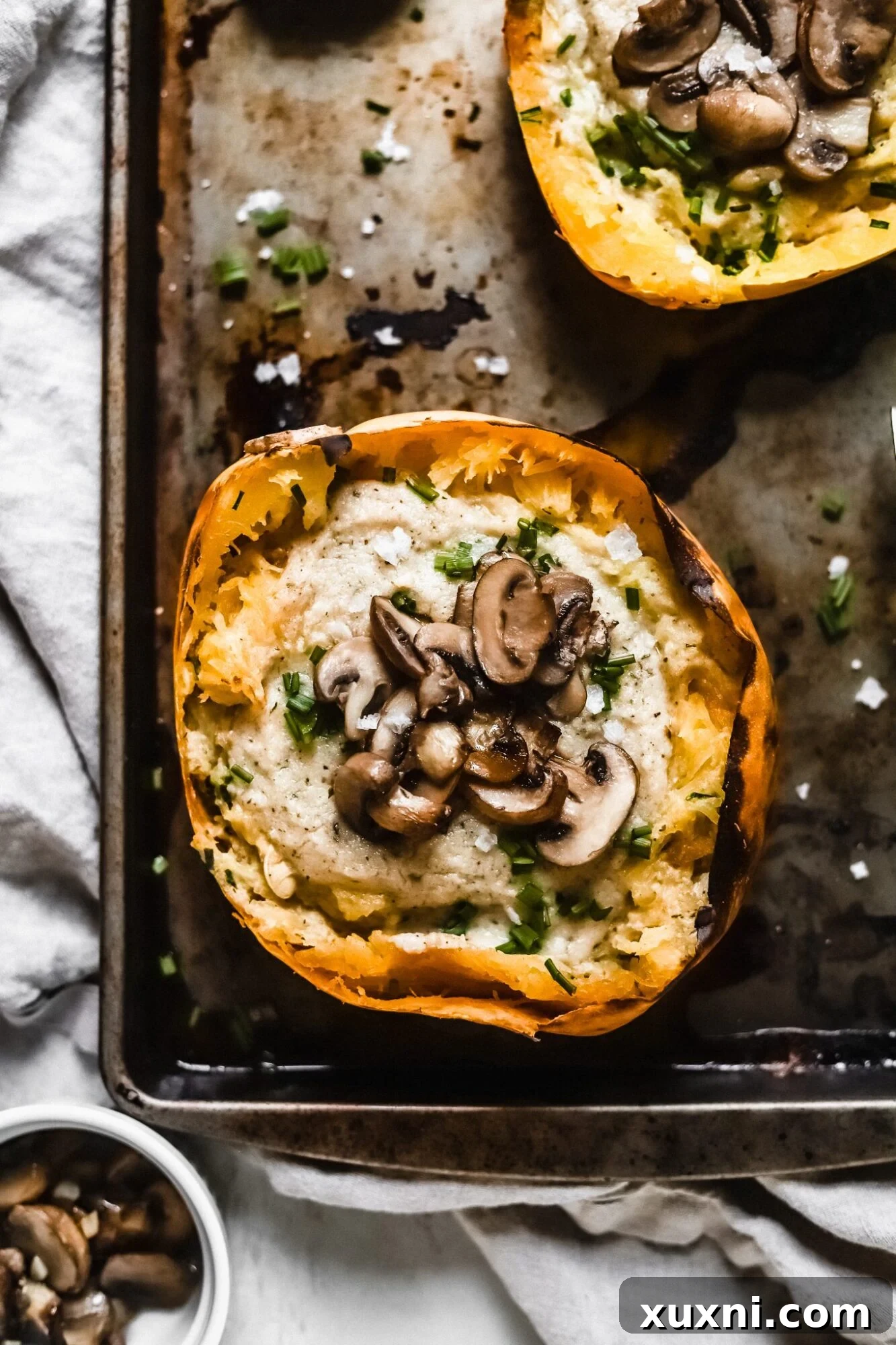 A close up of a single spaghetti squash boat, perfectly baked and garnished with fresh herbs, ready to be savored.