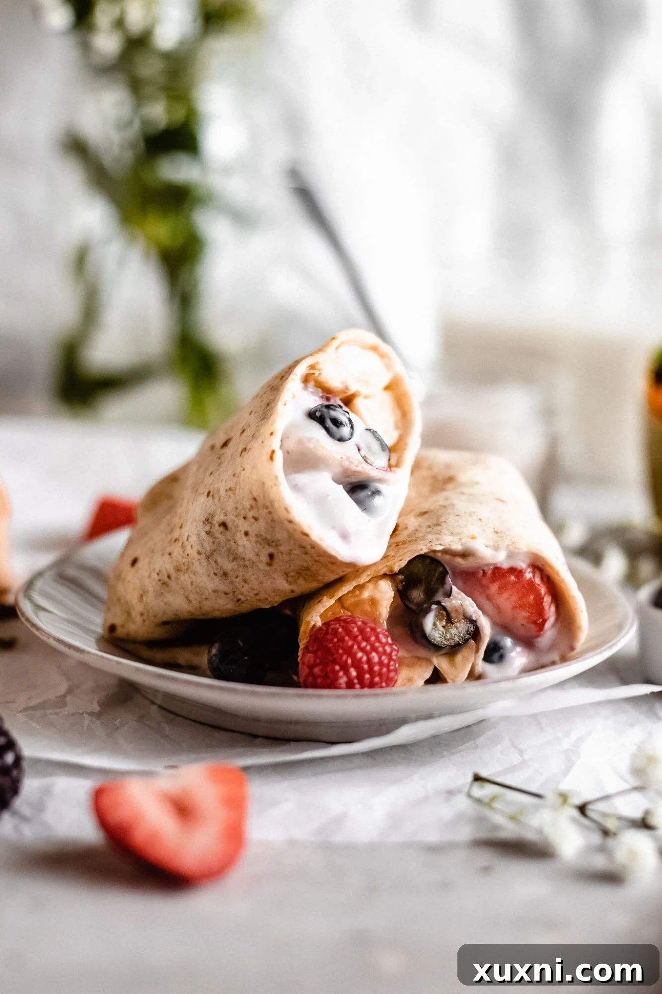 A sweet berry and yogurt breakfast burrito, showcasing the colorful ingredients