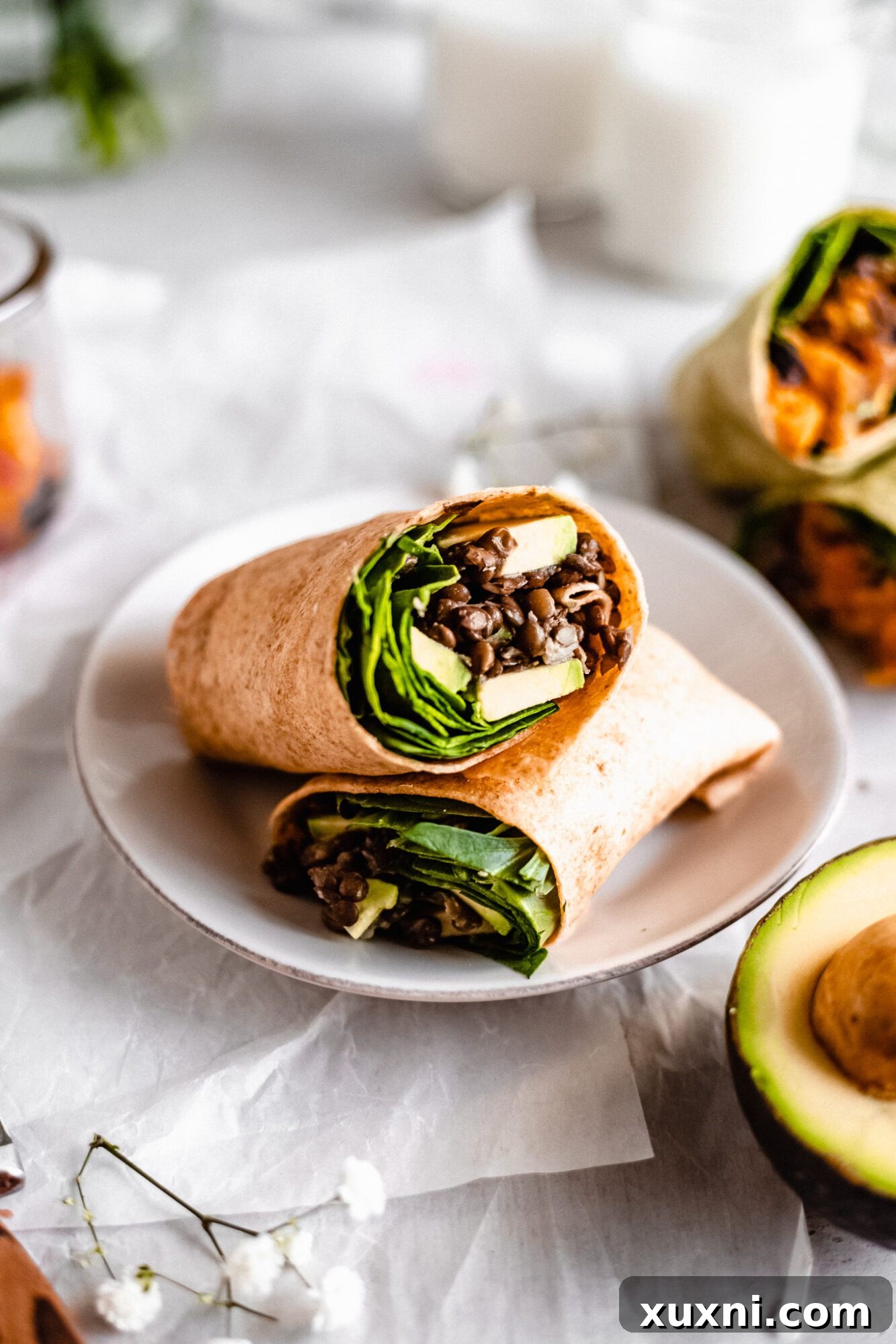A savory Moroccan lentil and avocado breakfast burrito, showing the rich, spiced filling