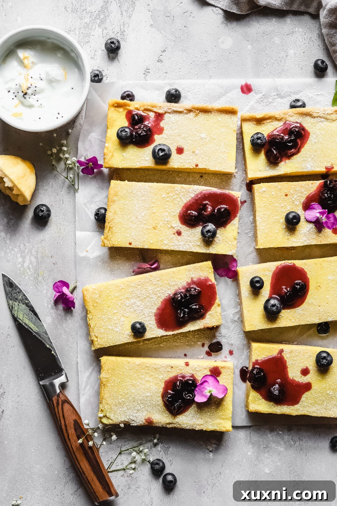 close up of lemon bars with blueberry jam