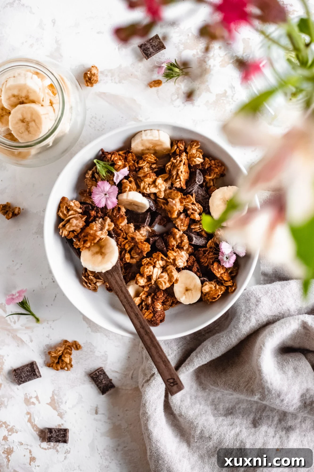 An overhead shot showing the raw ingredients for granola, particularly a bowl of oats, highlighting the natural components.