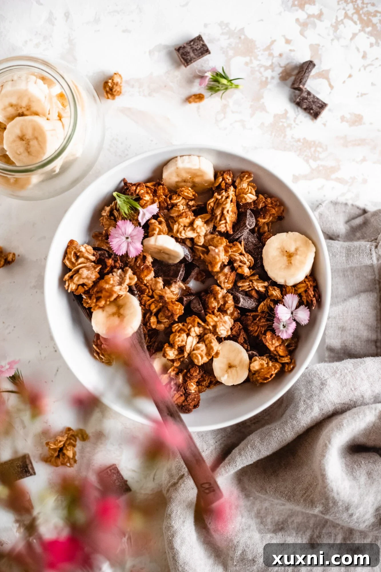 An overhead view of a beautifully prepared bowl of banana bread granola, enticing and ready to be enjoyed.