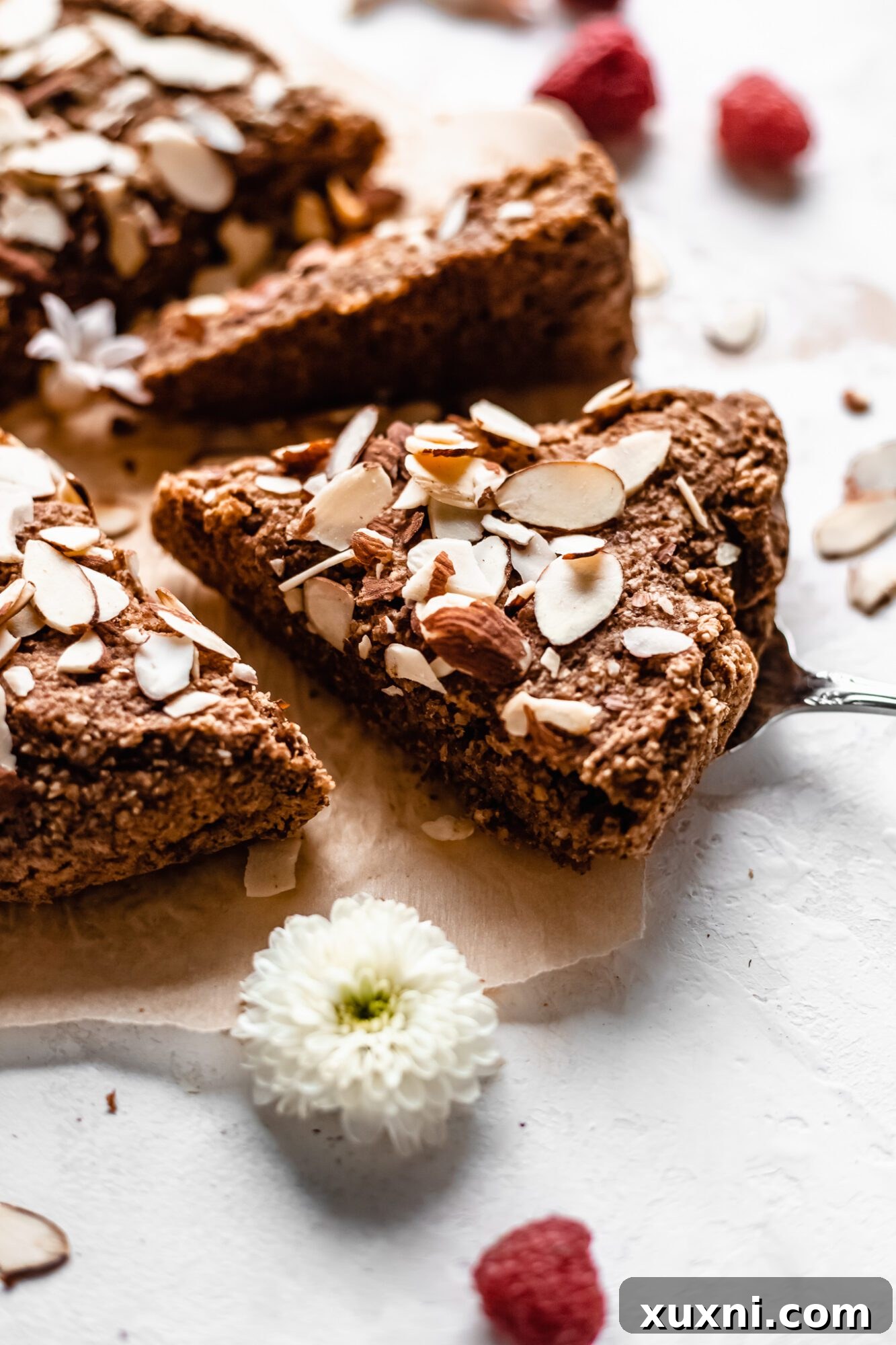 Close up view of a perfectly sliced almond cake, showcasing its moist texture