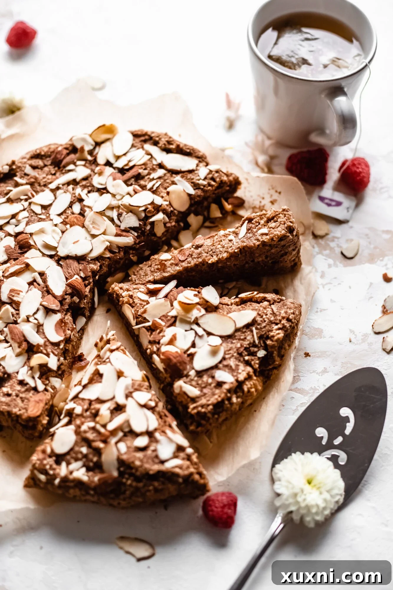 Almond cake served with a cup of tea and a tea bag, emphasizing the perfect pairing