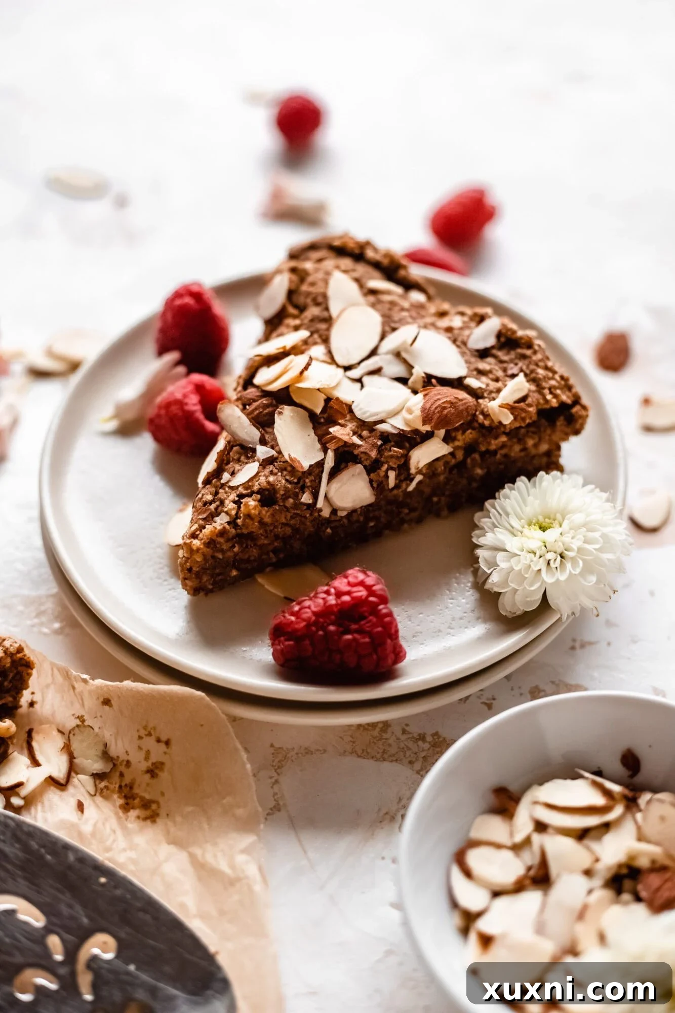 A beautiful slice of almond cake, presented on a white plate
