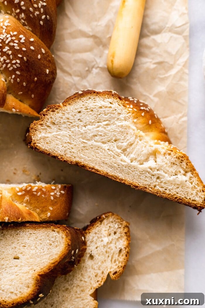 sliced vegan challah bread on a rustic wooden board