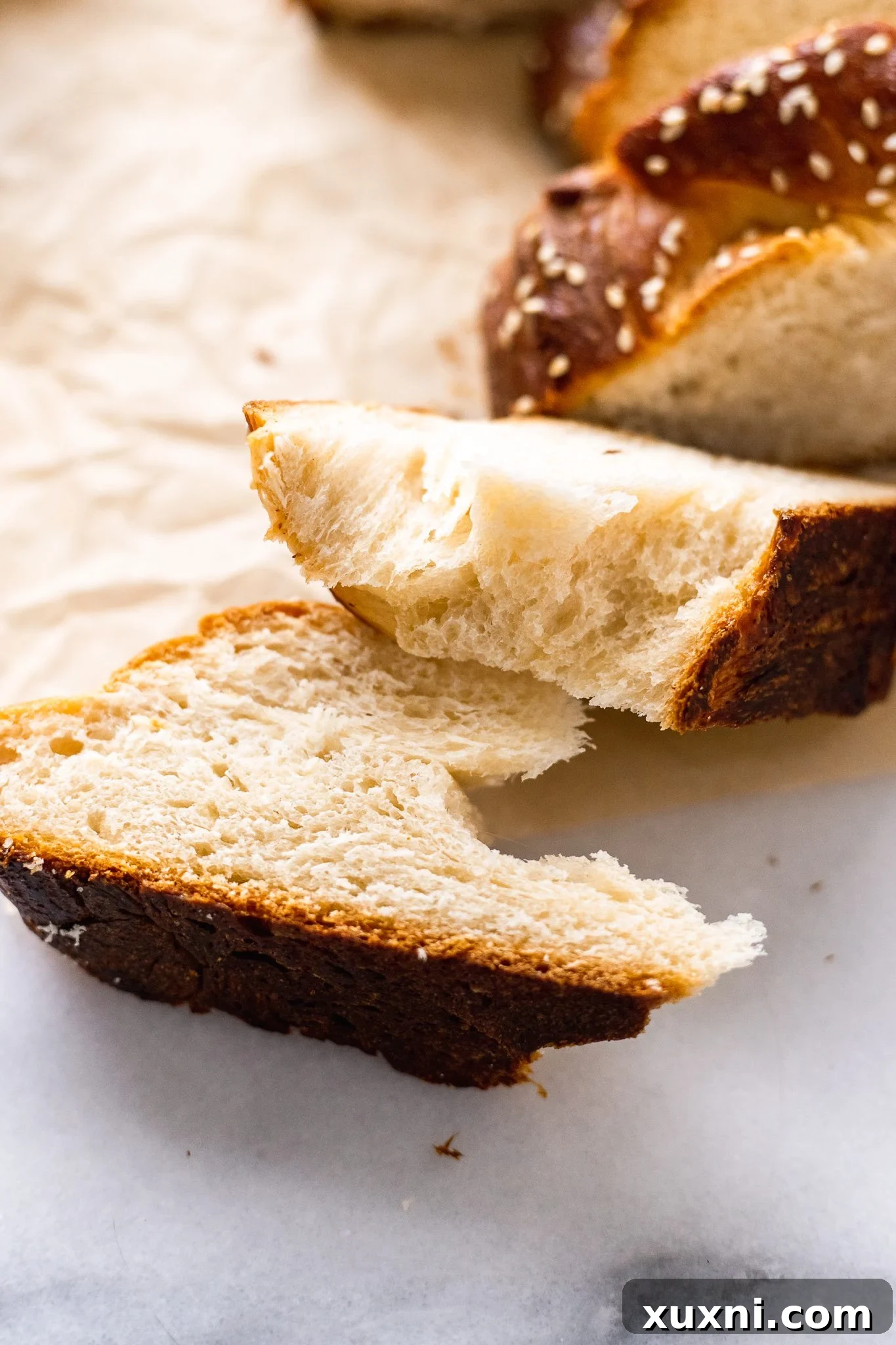 sliced vegan challah bread revealing a fluffy interior