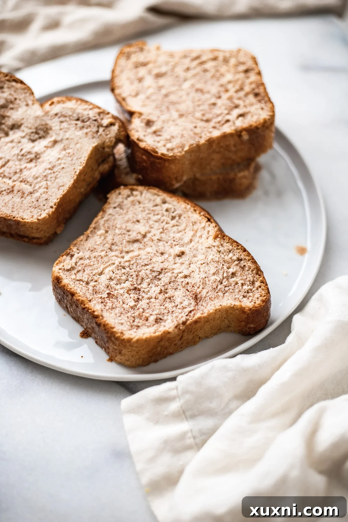 soaked vegan French toast on a plate before being cooked.