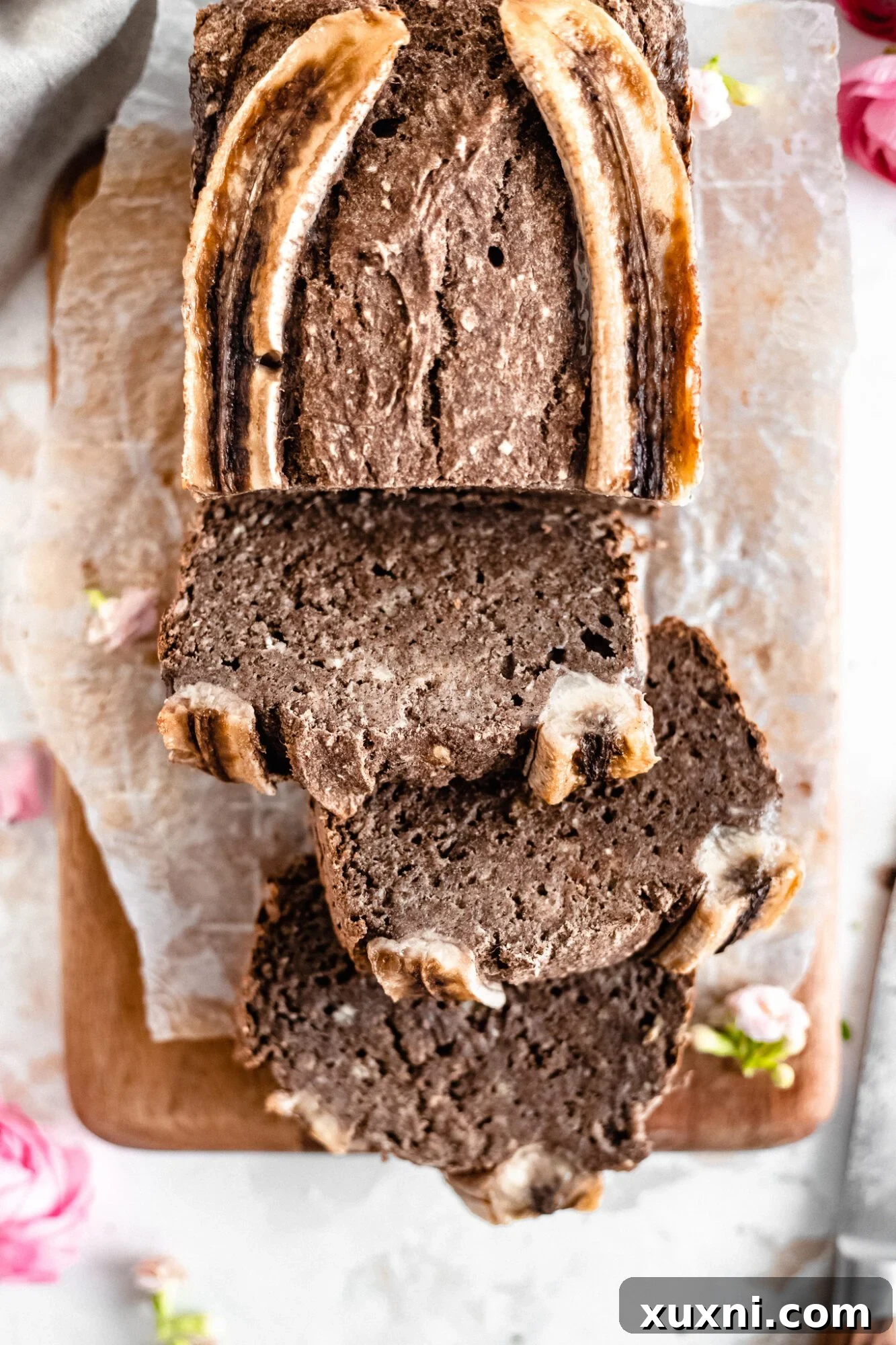 Effortless One-Bowl Vegan Gluten-Free Banana Bread 2 banana bread slices on a wooden board