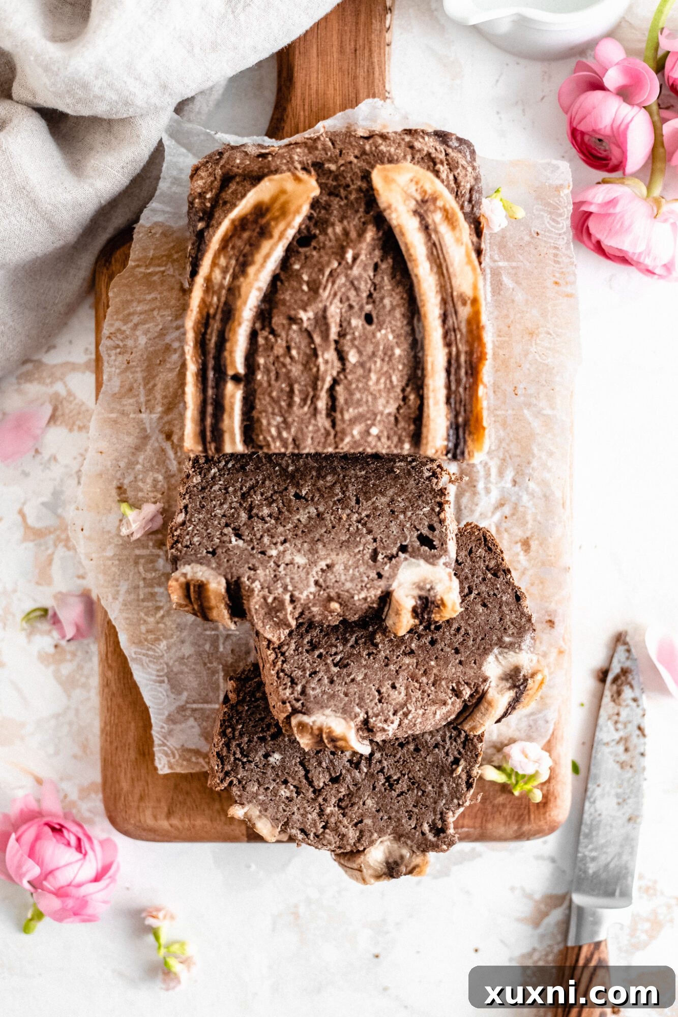 Effortless One-Bowl Vegan Gluten-Free Banana Bread 7 multiple slices of vegan banana bread on a serving plate