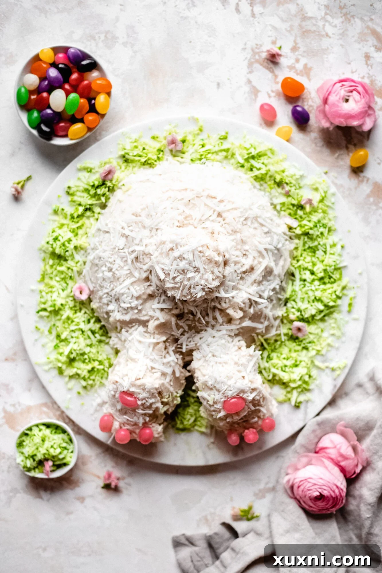 The completed vegan bunny butt cake, decorated with coconut flakes and jelly beans for a festive look