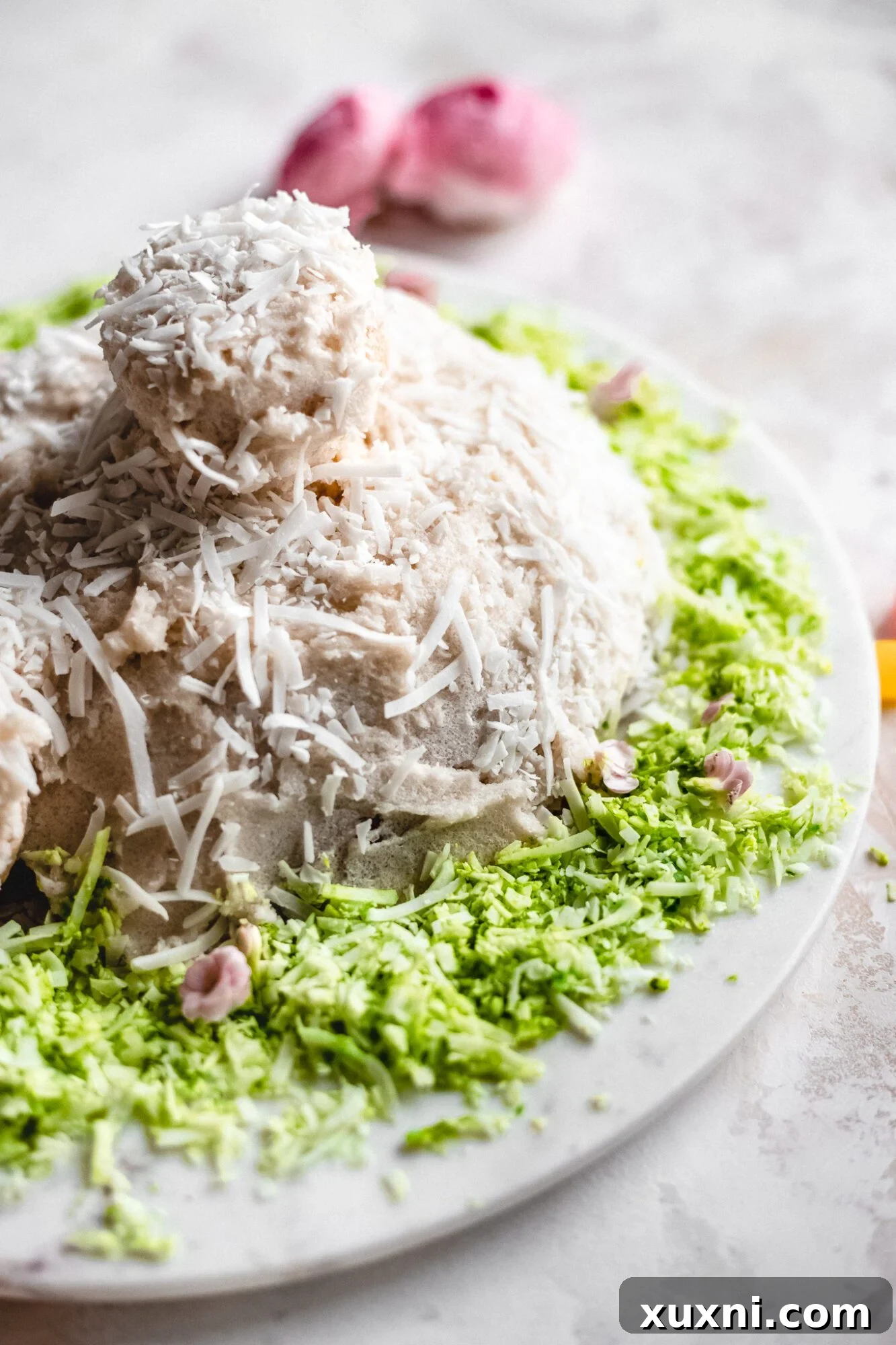 Side view of the completed vegan bunny butt cake, highlighting its adorable shape and decoration