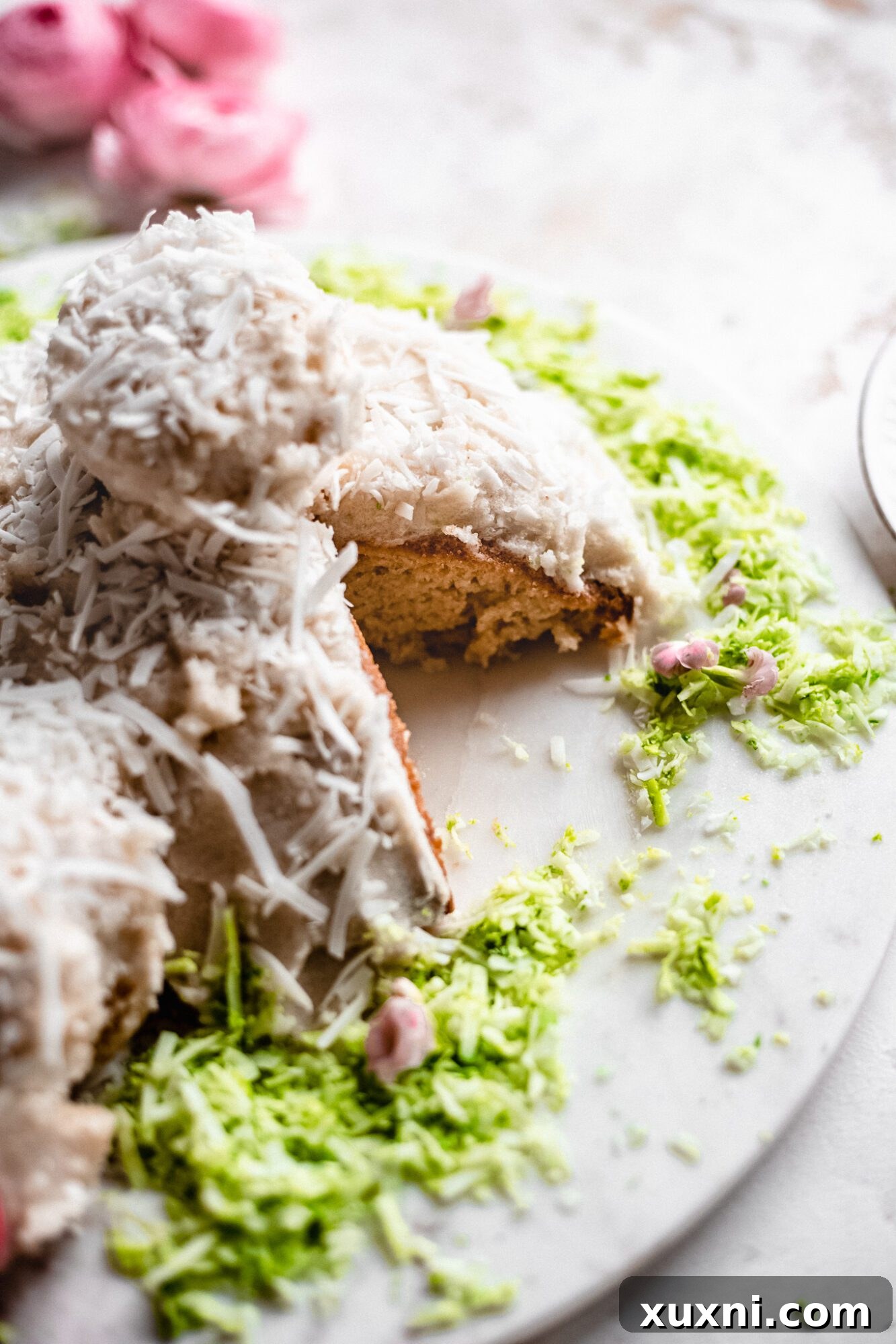 A slice of vegan bunny butt cake revealing its moist texture and coconut flakes, ready to be enjoyed