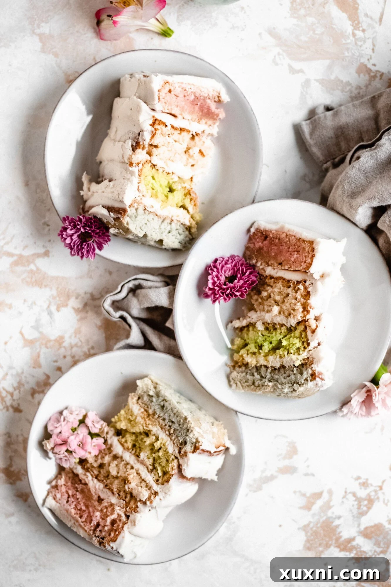 Baked cake layers, un-frosted, neatly stacked on plates, ready for assembly.