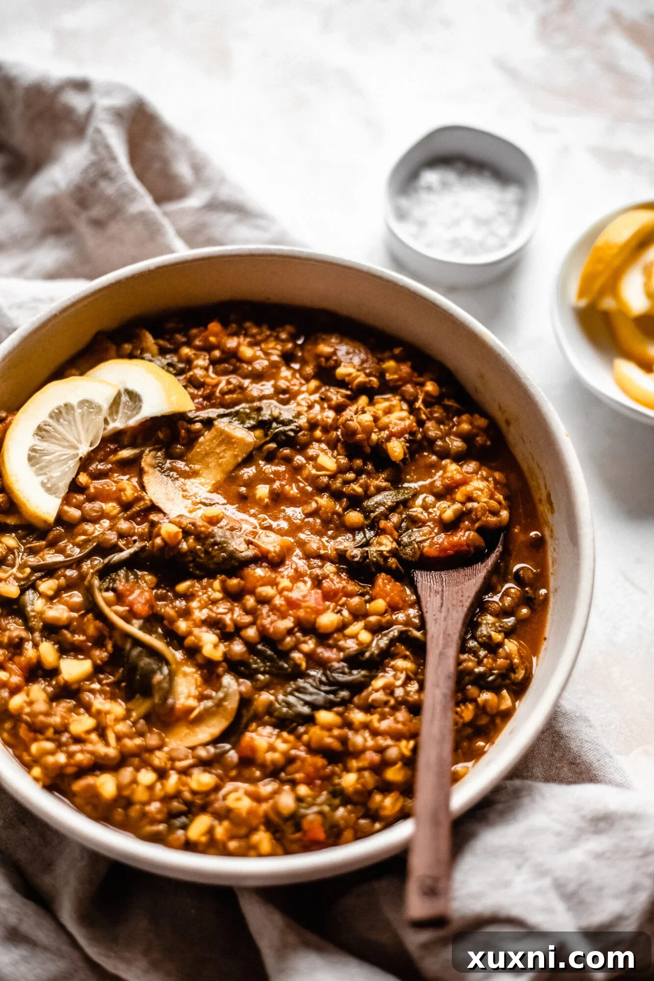 A beautifully presented bowl of steaming vegan lentil soup, ready to be enjoyed.