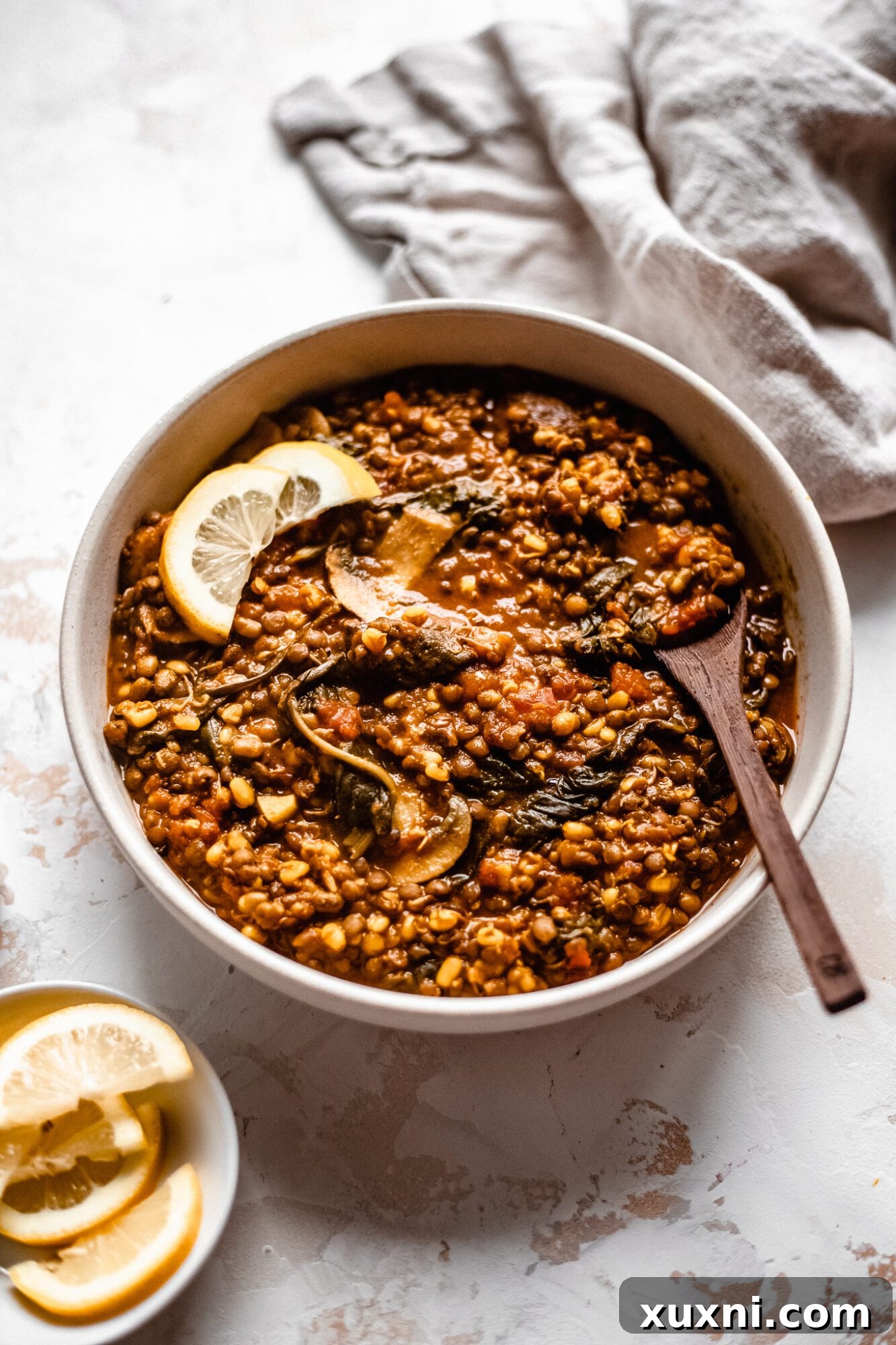 A colorful bowl of vegan lentil soup, showcasing a variety of wholesome ingredients.