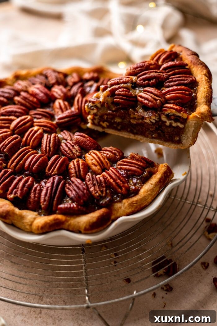 slice of pecan pie being removed from pie