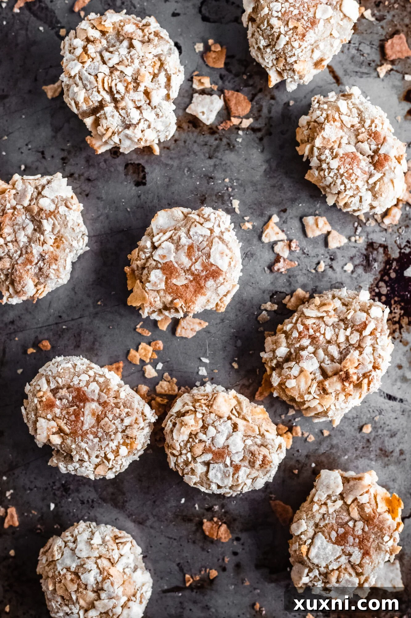A baking tray filled with freshly baked, golden-brown vegan cauliflower nuggets, glistening and ready to be served.