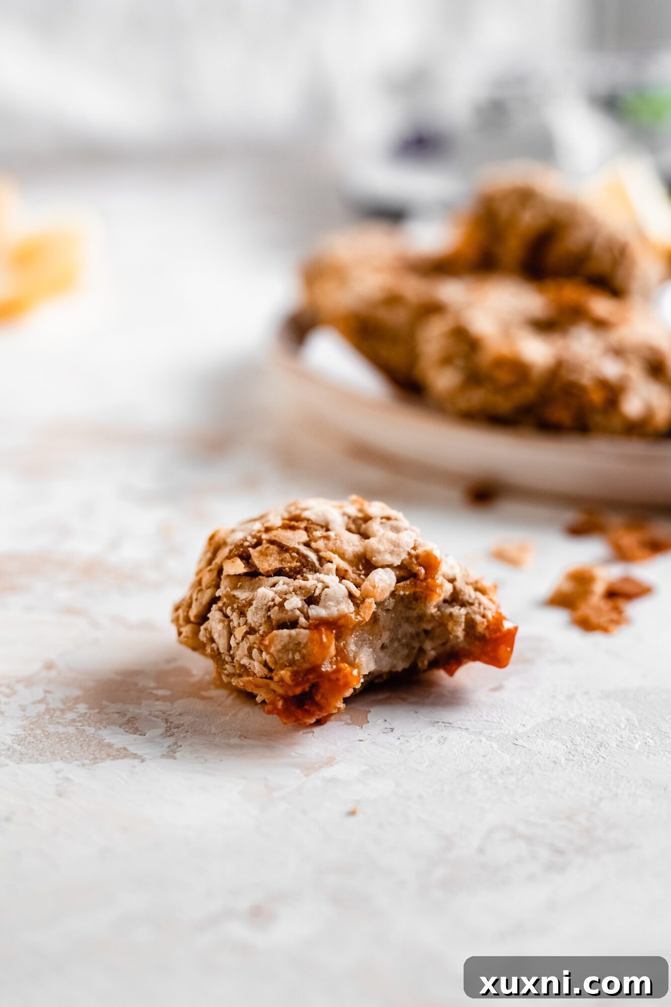 A vegan cauliflower nugget with a bite taken out of it, revealing its soft, flavorful interior and crispy breading.