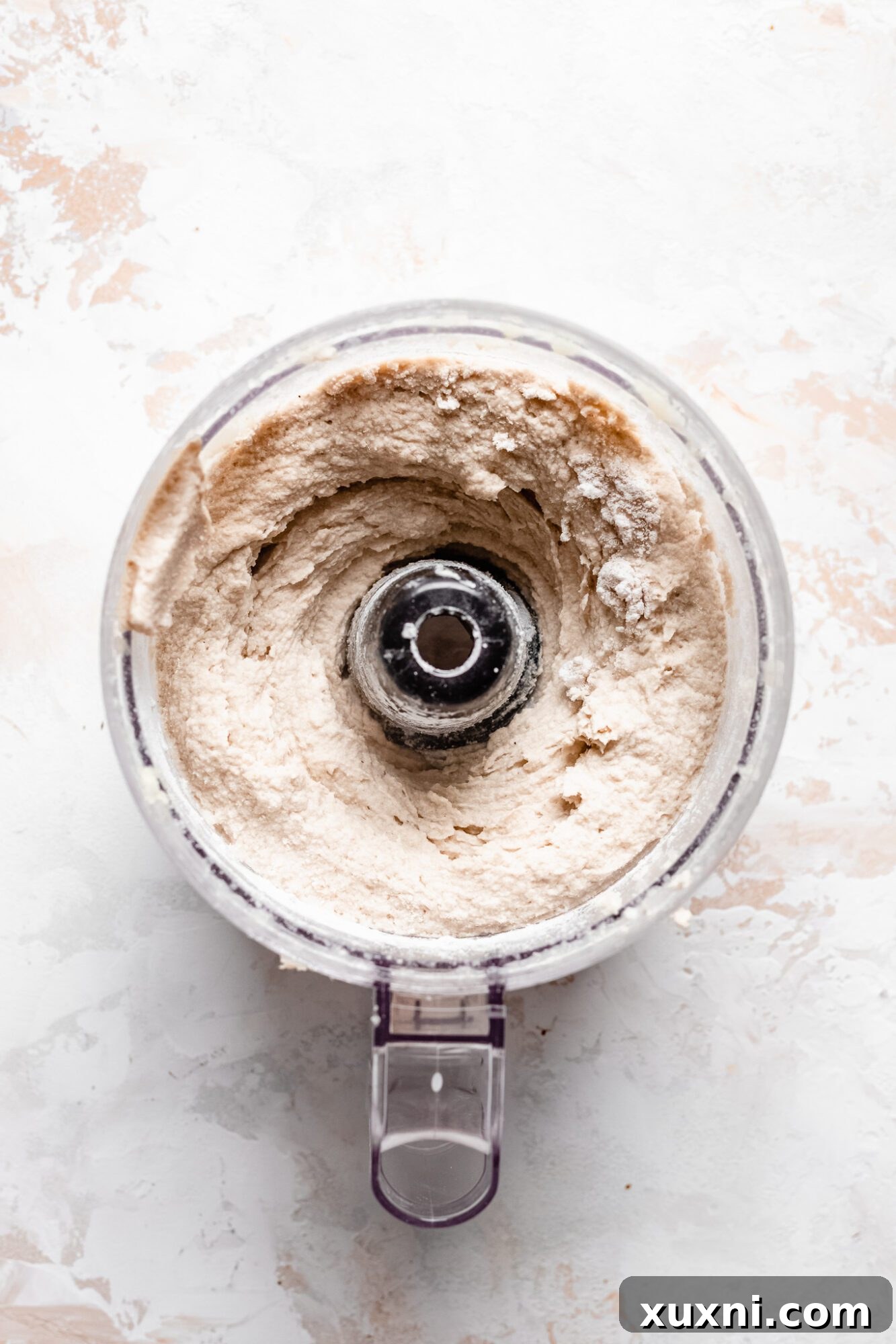 A bowl of sticky cauliflower nugget dough, mixed and ready for shaping, showing its uniform texture.