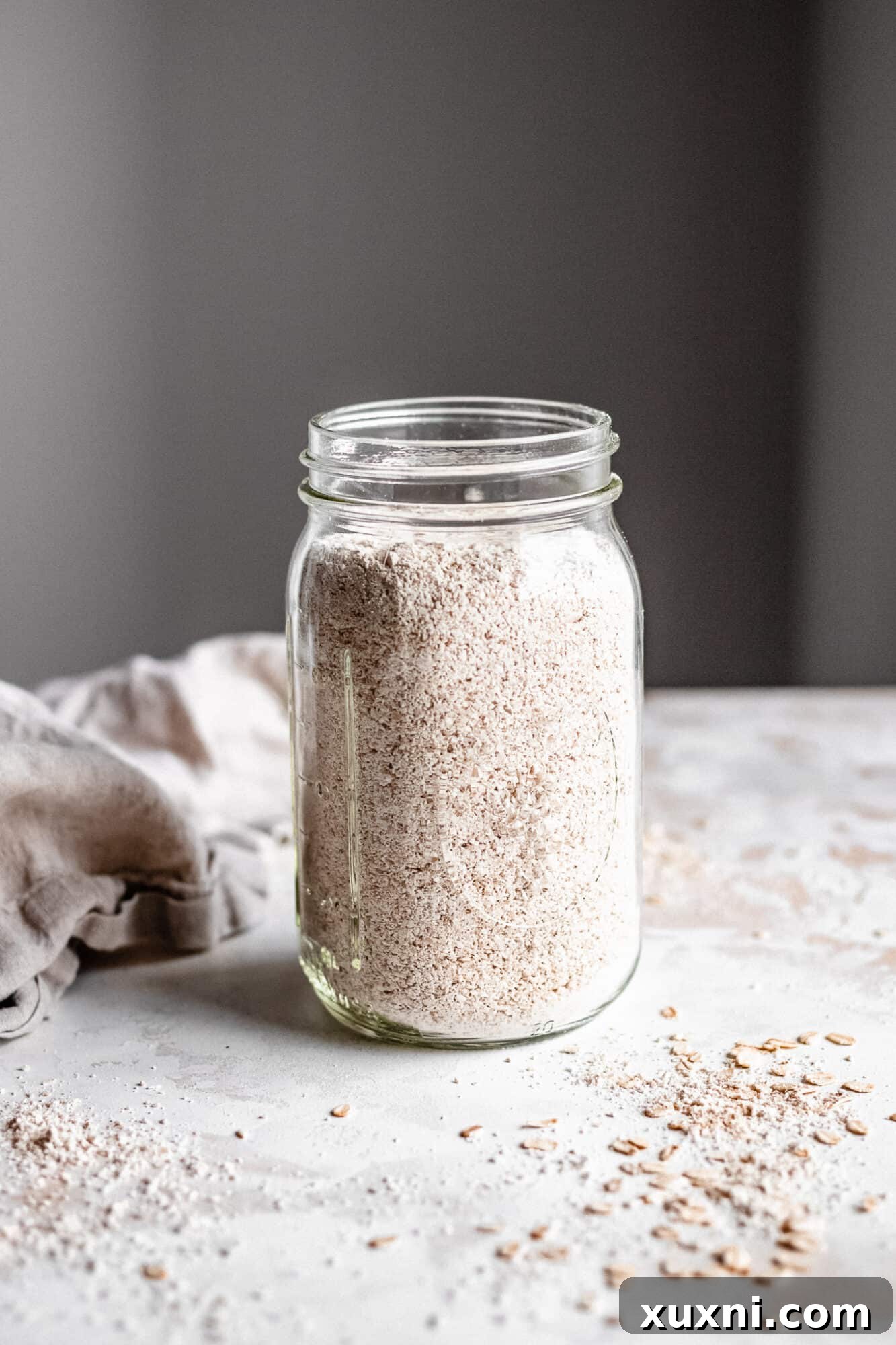 Another view of a jar full of homemade oat flour