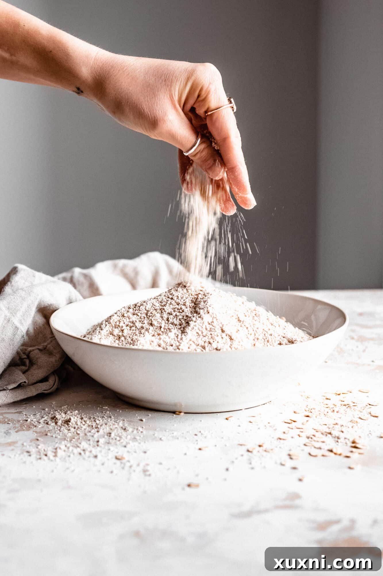 Hand showing the fine texture of oat flour