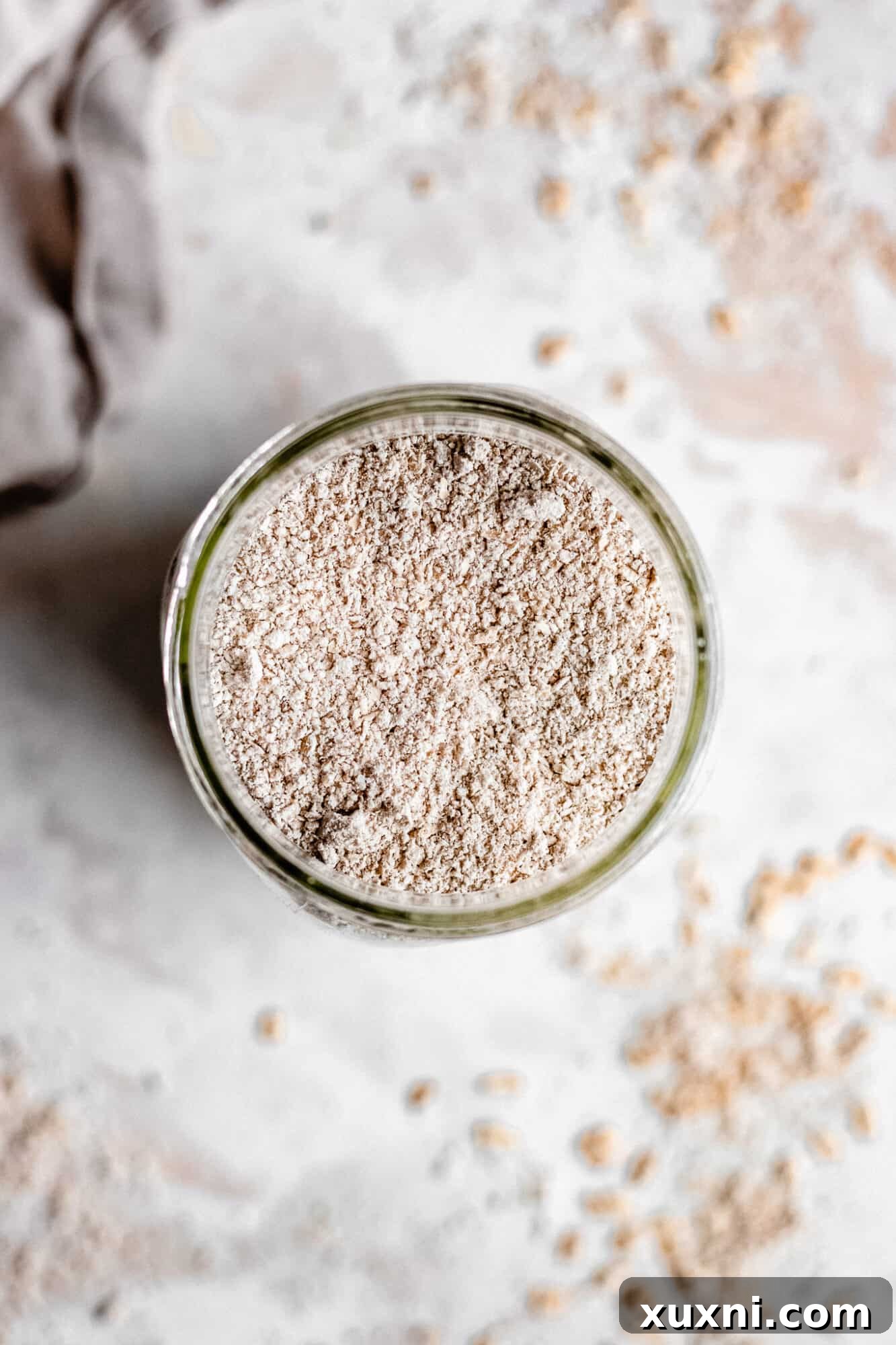 Homemade oat flour stored in a glass mason jar