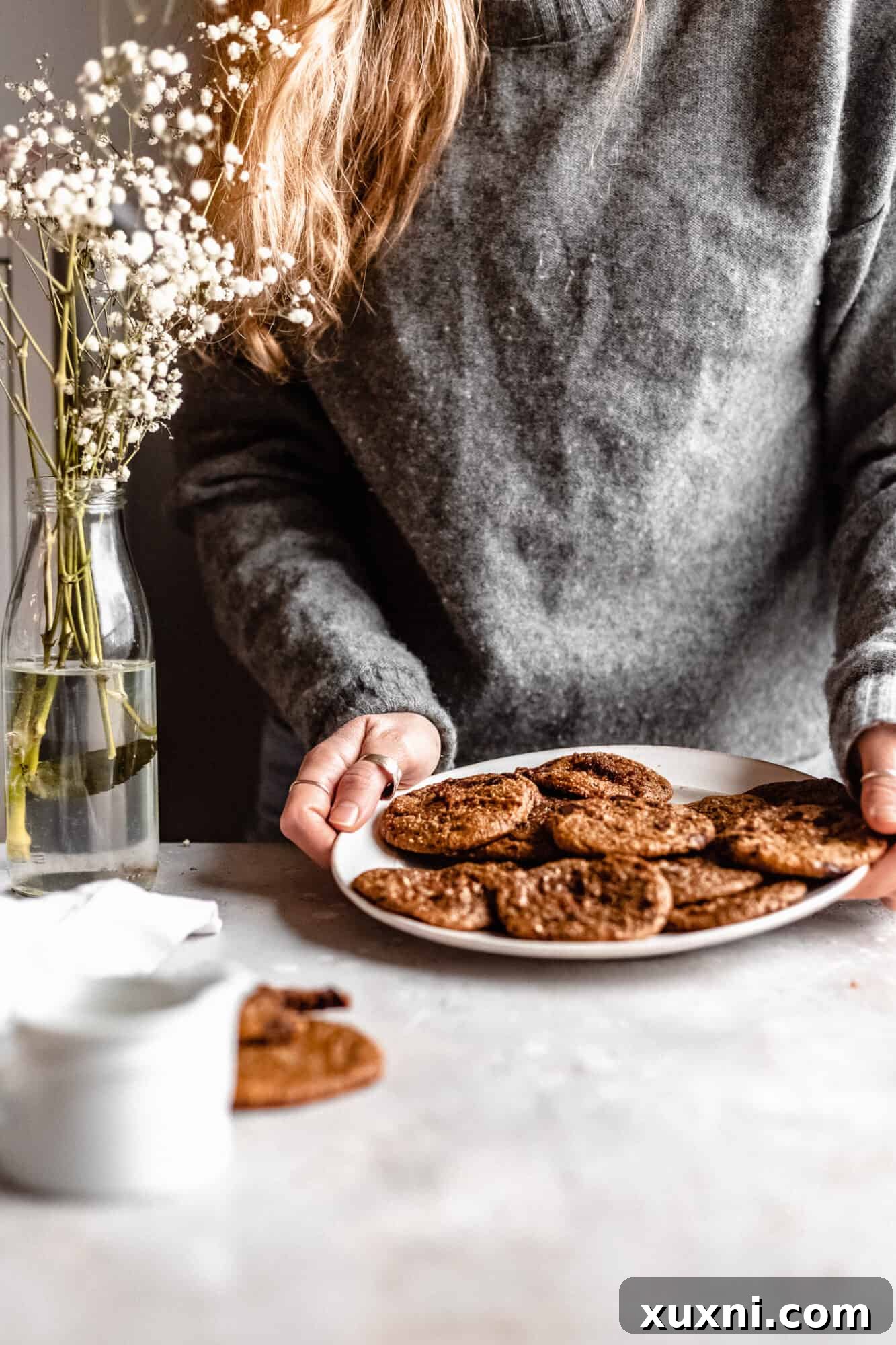hand placing chocolate chip cookies down