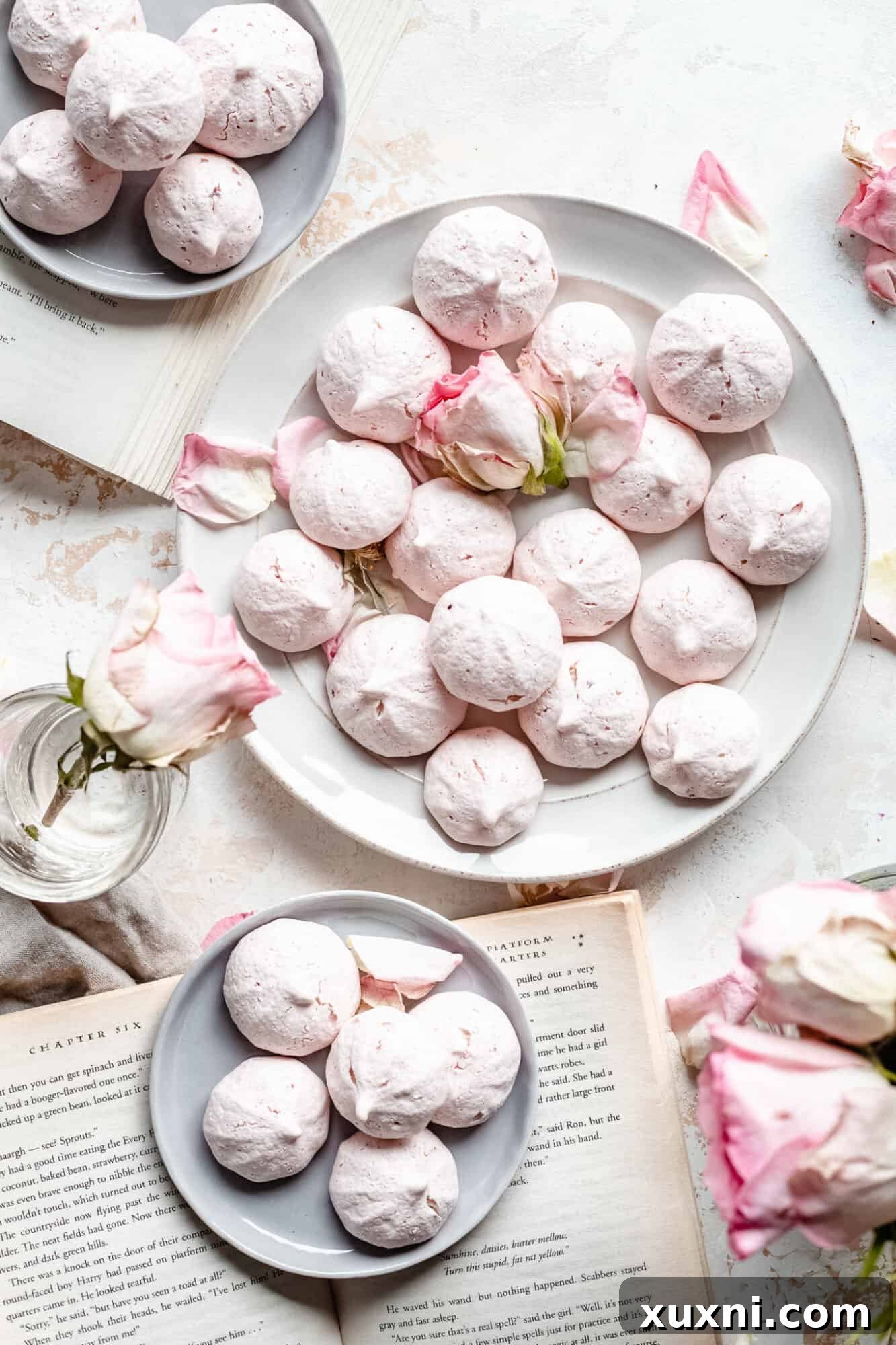 An assortment of freshly baked vegan meringue cookies artfully arranged on a rustic plate, ready for serving.