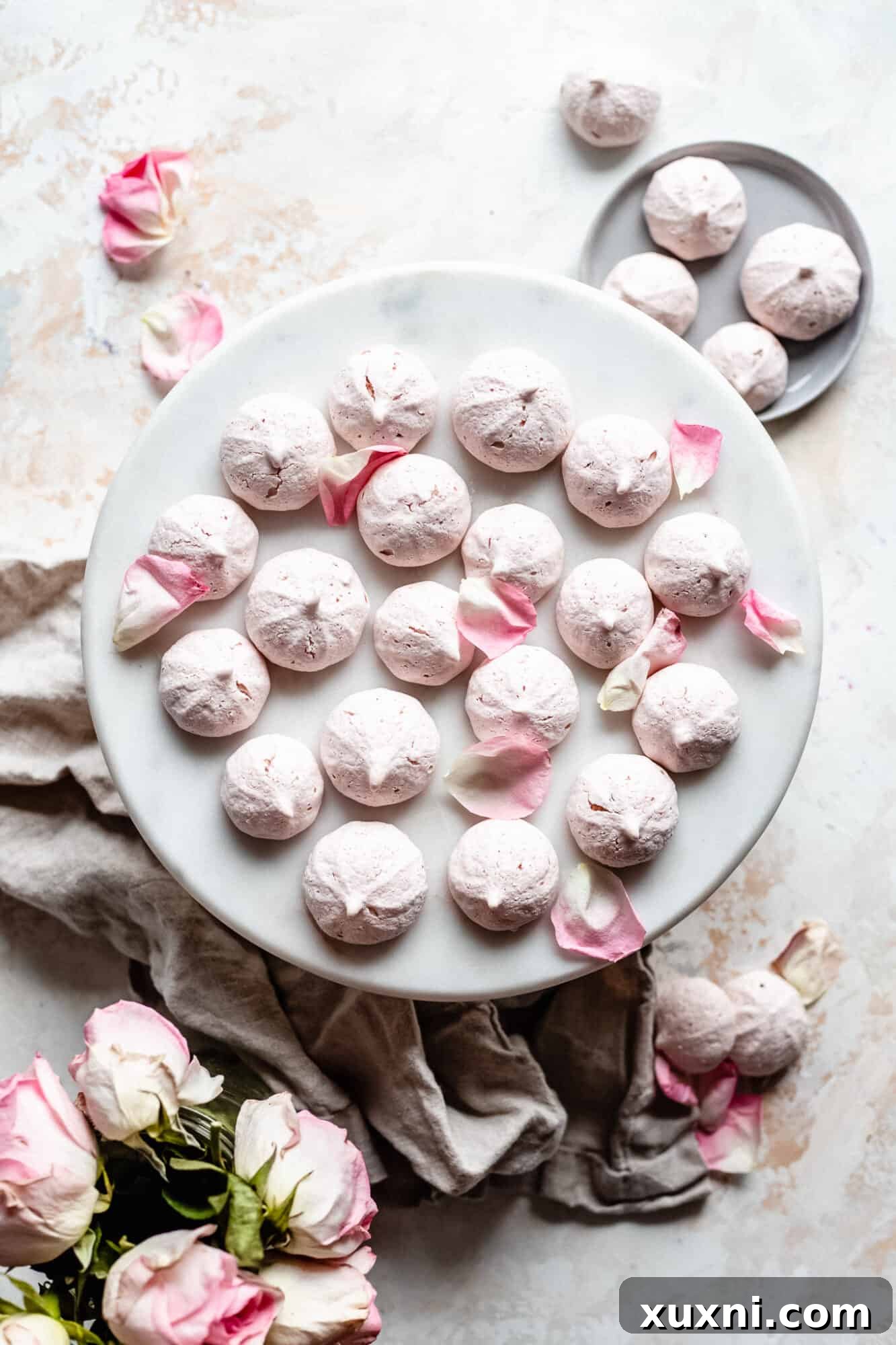 A beautiful display of light and crispy vegan meringue cookies on a serving plate, inviting a taste.