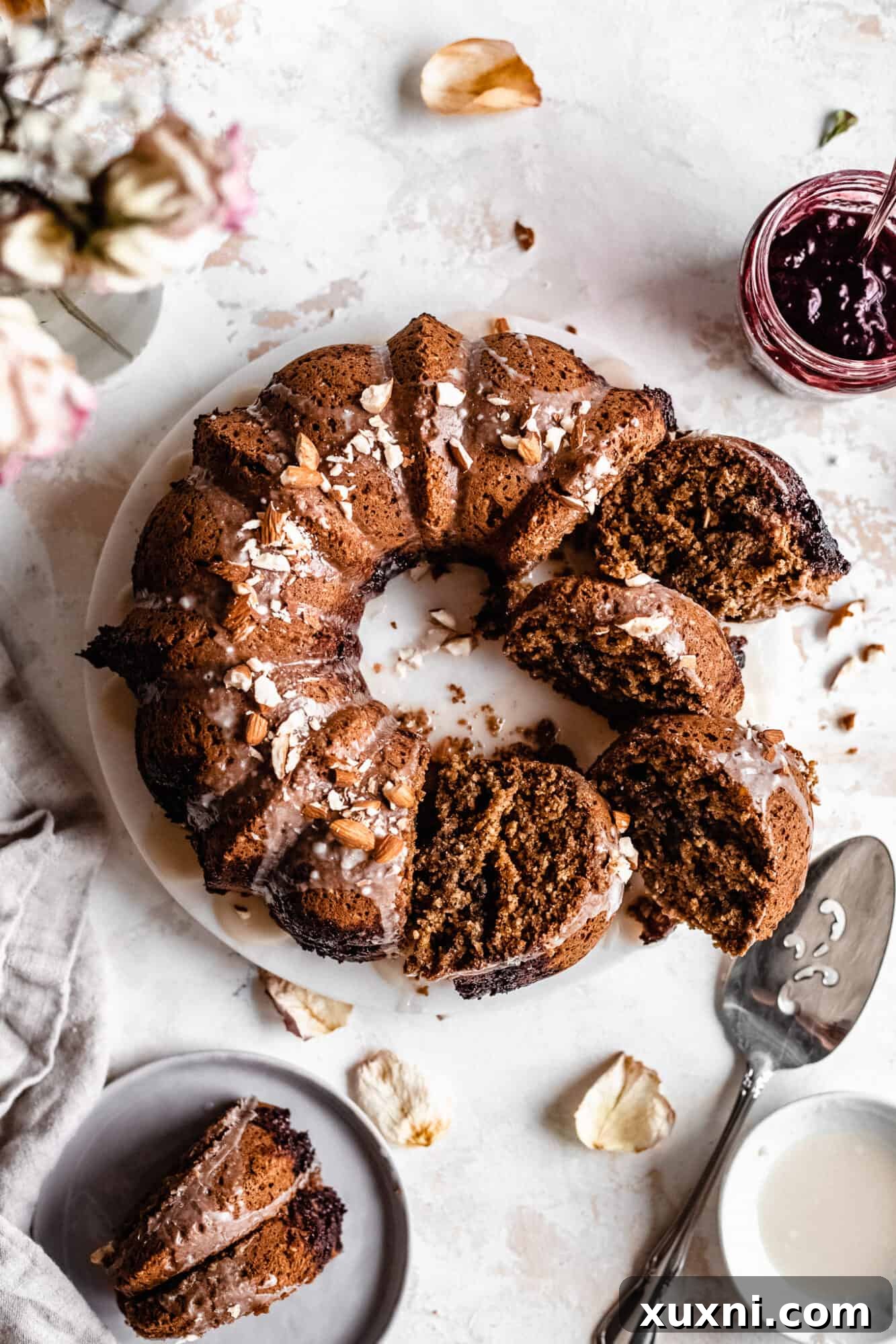 A beautifully decorated vegan almond cherry bundt cake, perfect for a healthier brunch.