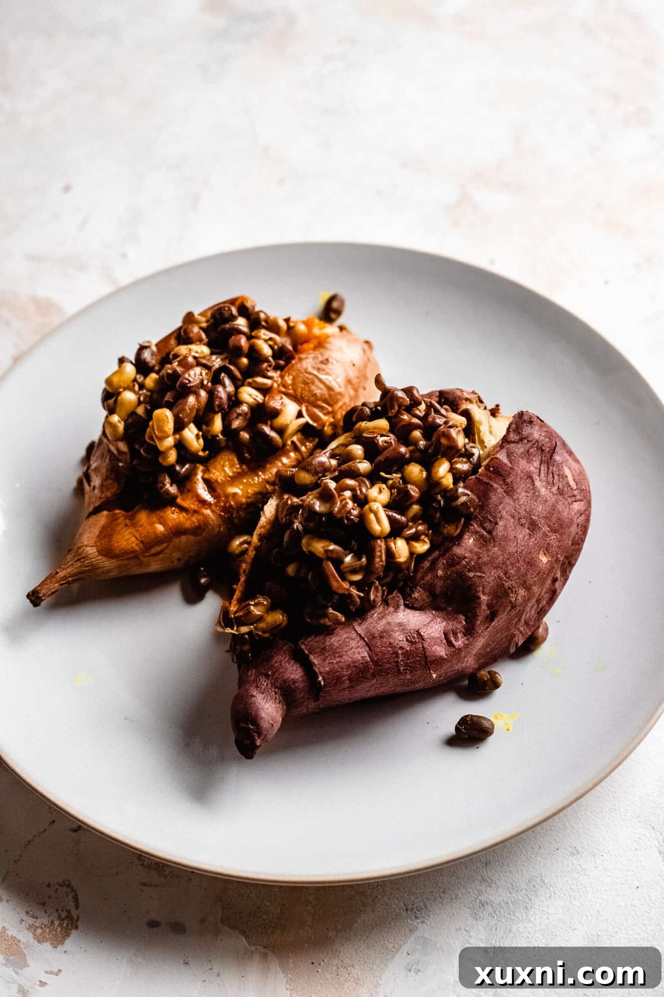 Two curry stuffed sweet potatoes, a wholesome and easy vegan pantry meal.