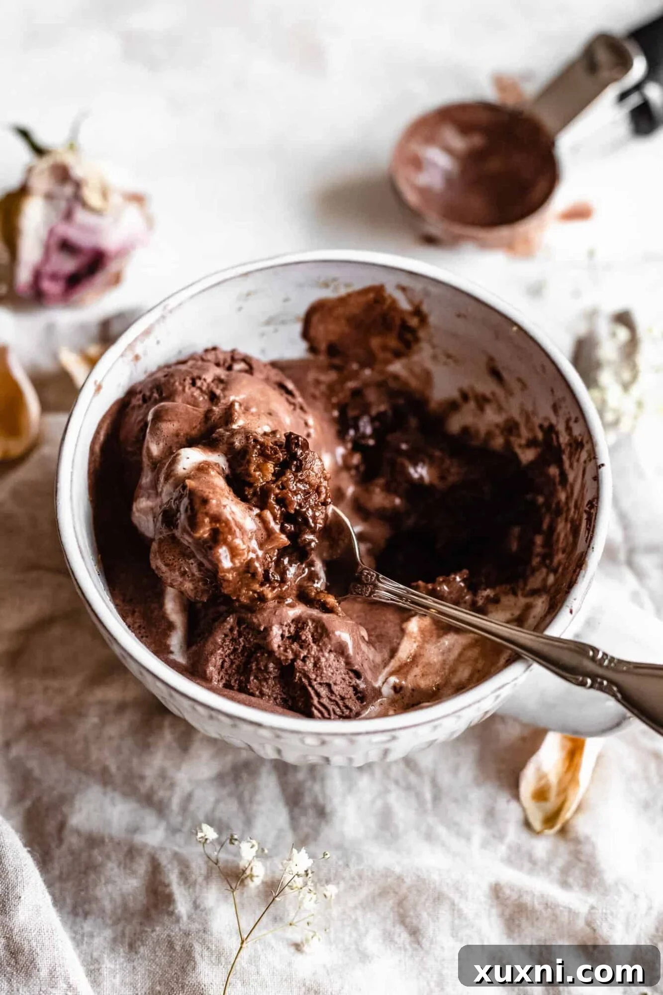 Gooey vegan chocolate chip mug cake with a spoon, highlighting its healthy, oil-free, gluten-free, and egg-free qualities