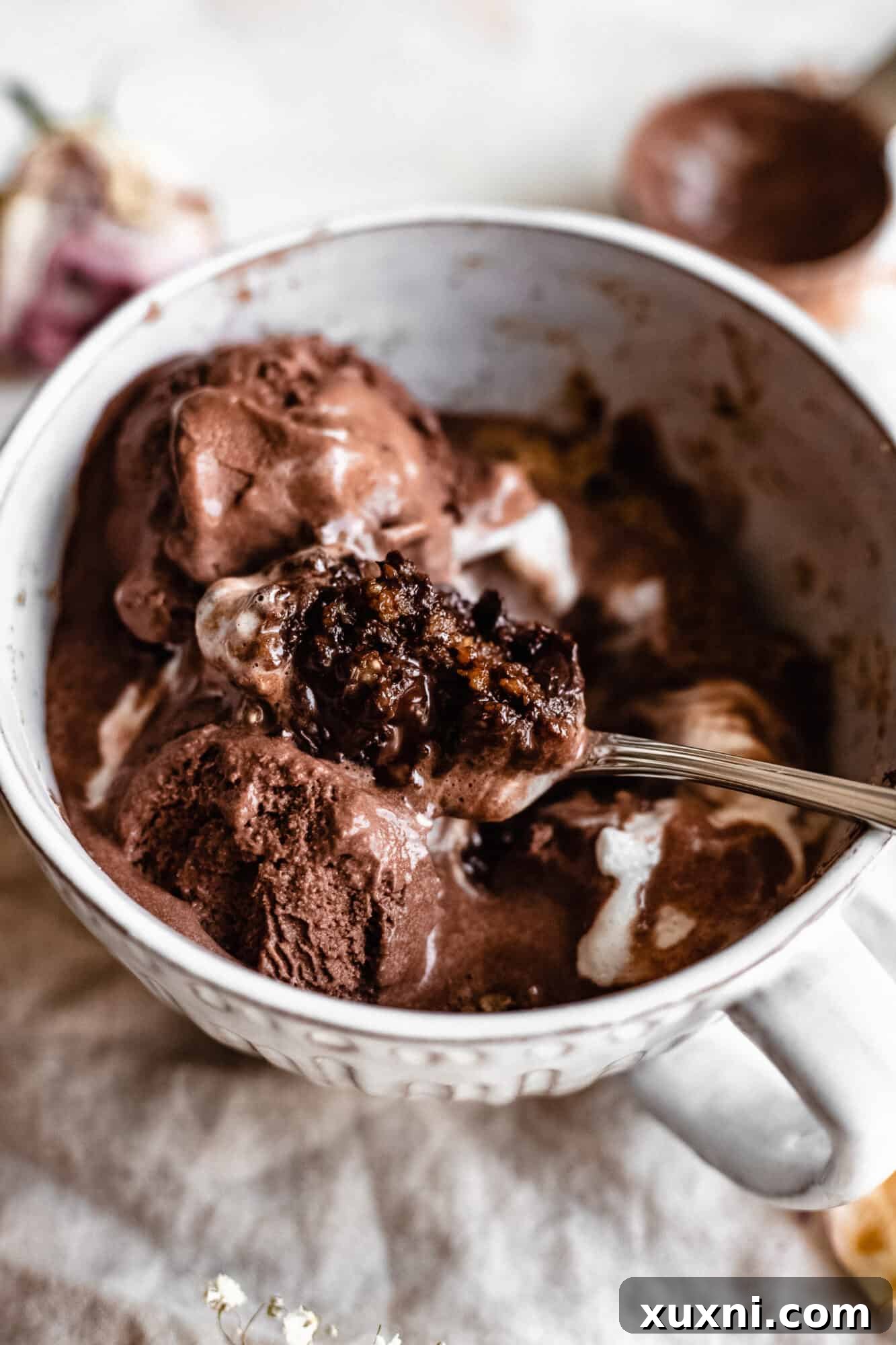 A spoonful of vegan vanilla mug cake, showcasing its delicate texture and appealing aroma