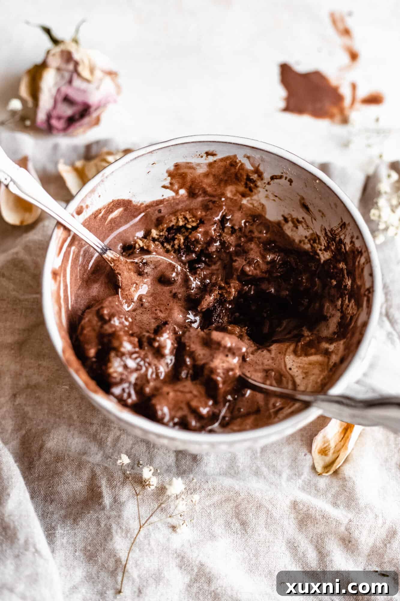 A half-eaten vegan mug cake, showing its moist and tender crumb texture