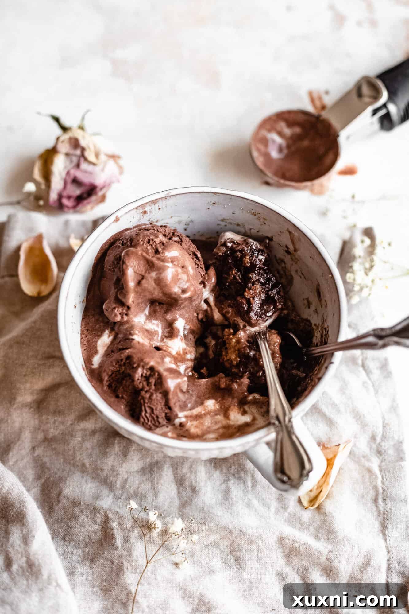 Two spoons ready to scoop into a healthy mug cake, symbolizing a shared moment