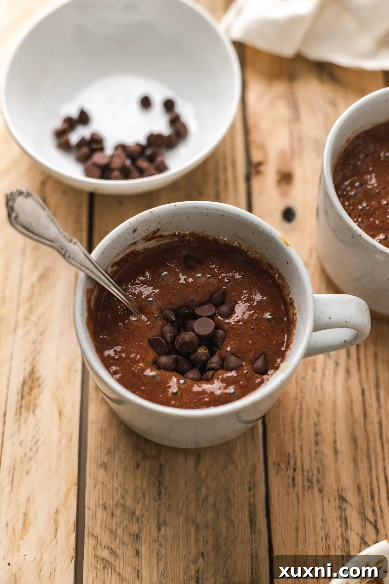 Magical Vegan Chocolate Mug Cake Gluten Free Oil Free Bliss 7 Smooth, rich chocolate mug cake batter with visible chocolate chips, before microwaving.