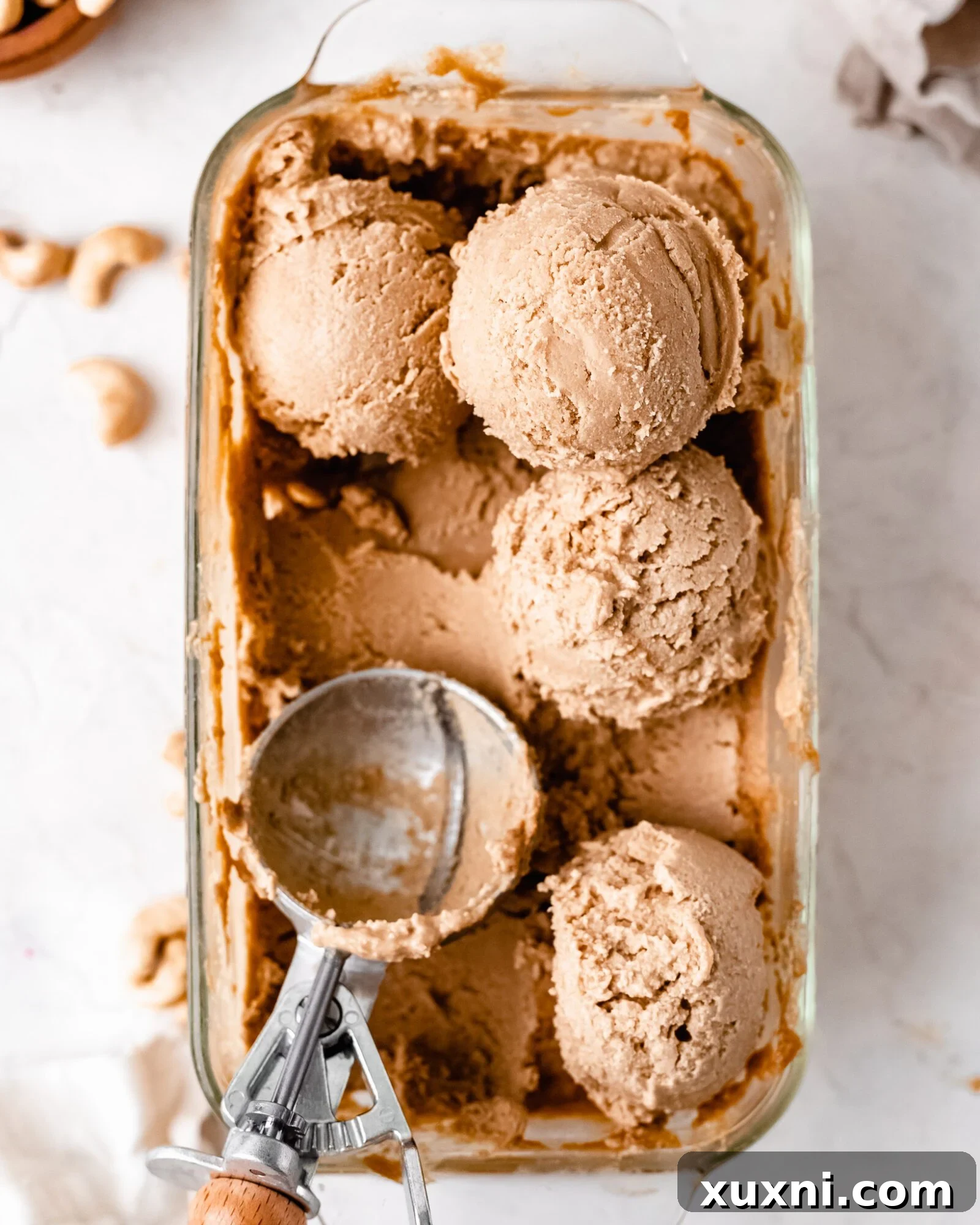 Scooped vegan vanilla cashew ice cream in a bowl, showing its creamy texture.